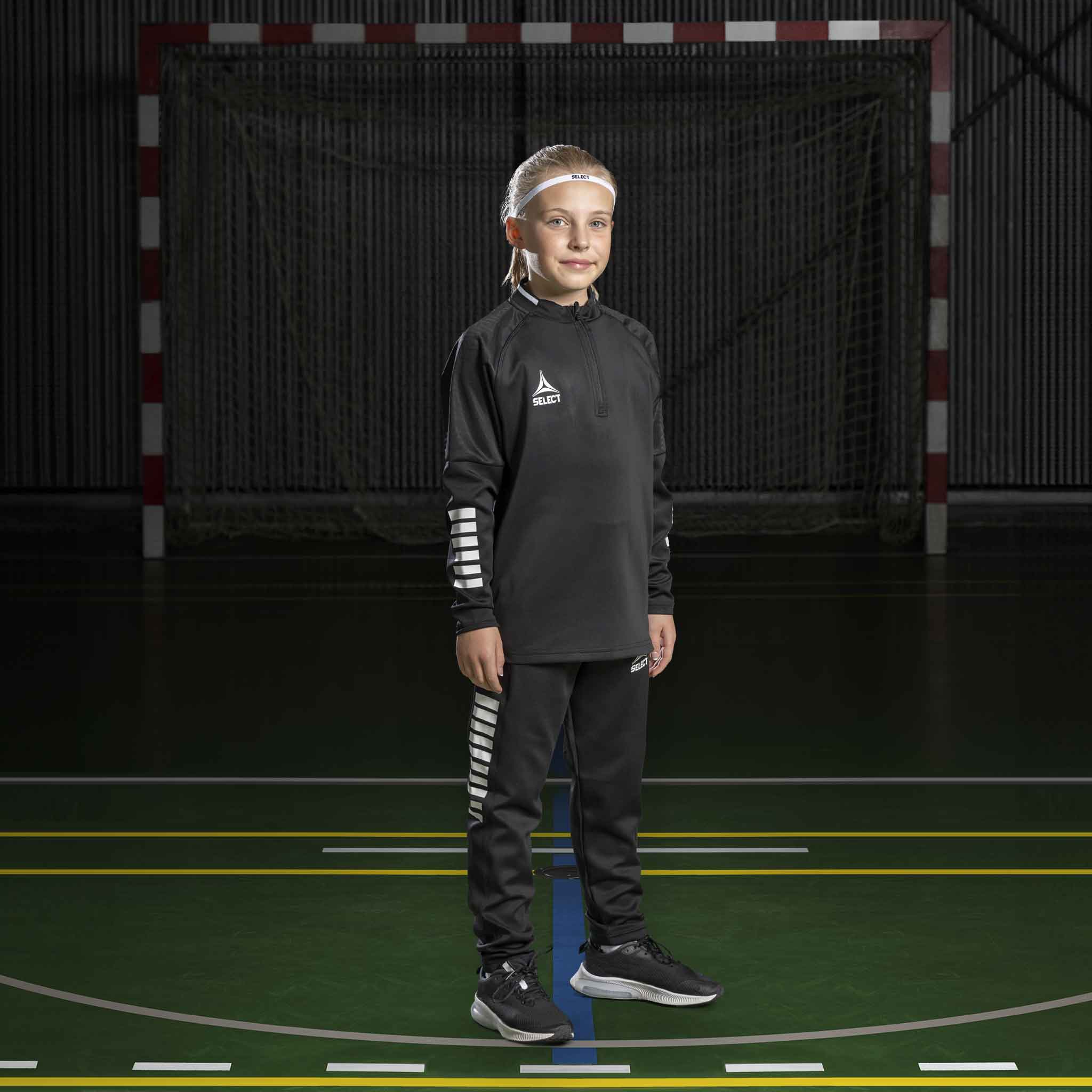 Boy handball player in black Training sweat 1/2 zip Monaco v24, Match & Training wear, on indoor court.