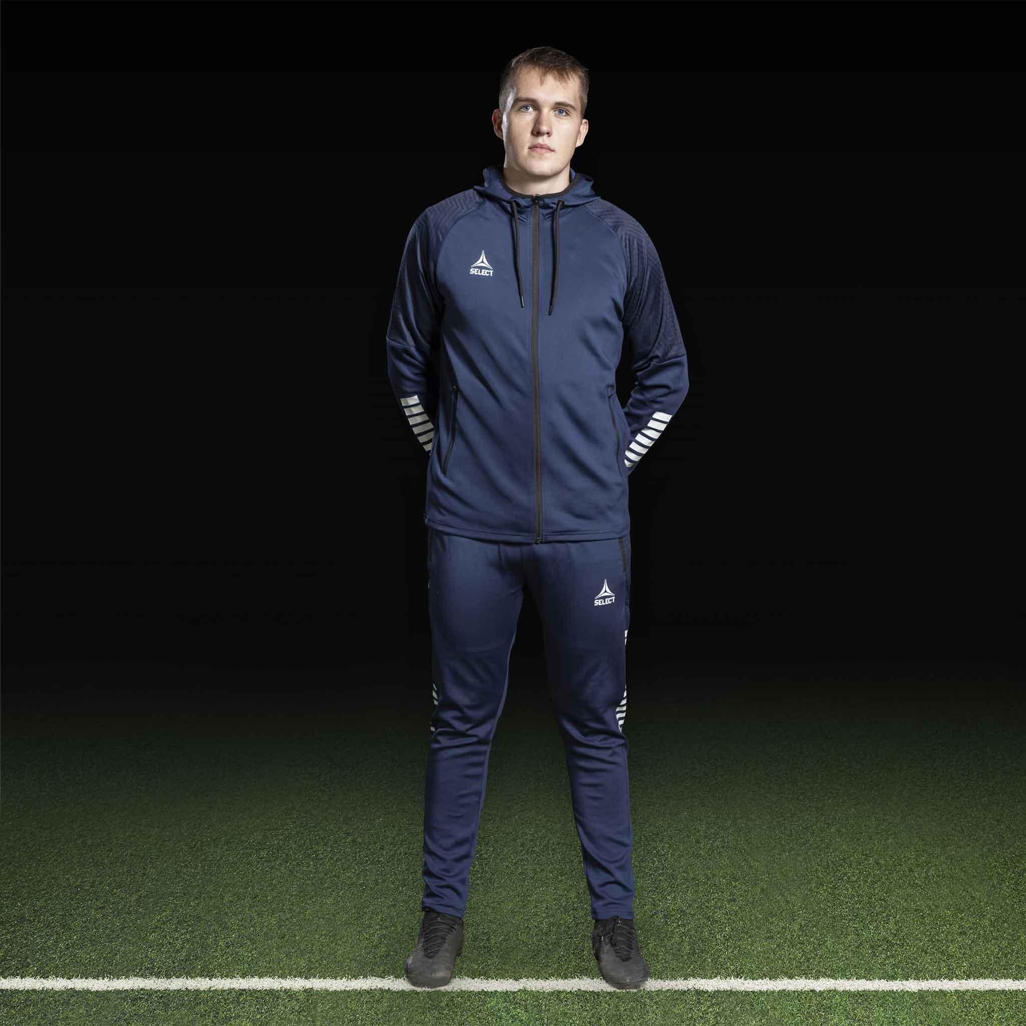 Male football player in navy and white Zip hoodie Monaco v24, Match & Training wear, front view.