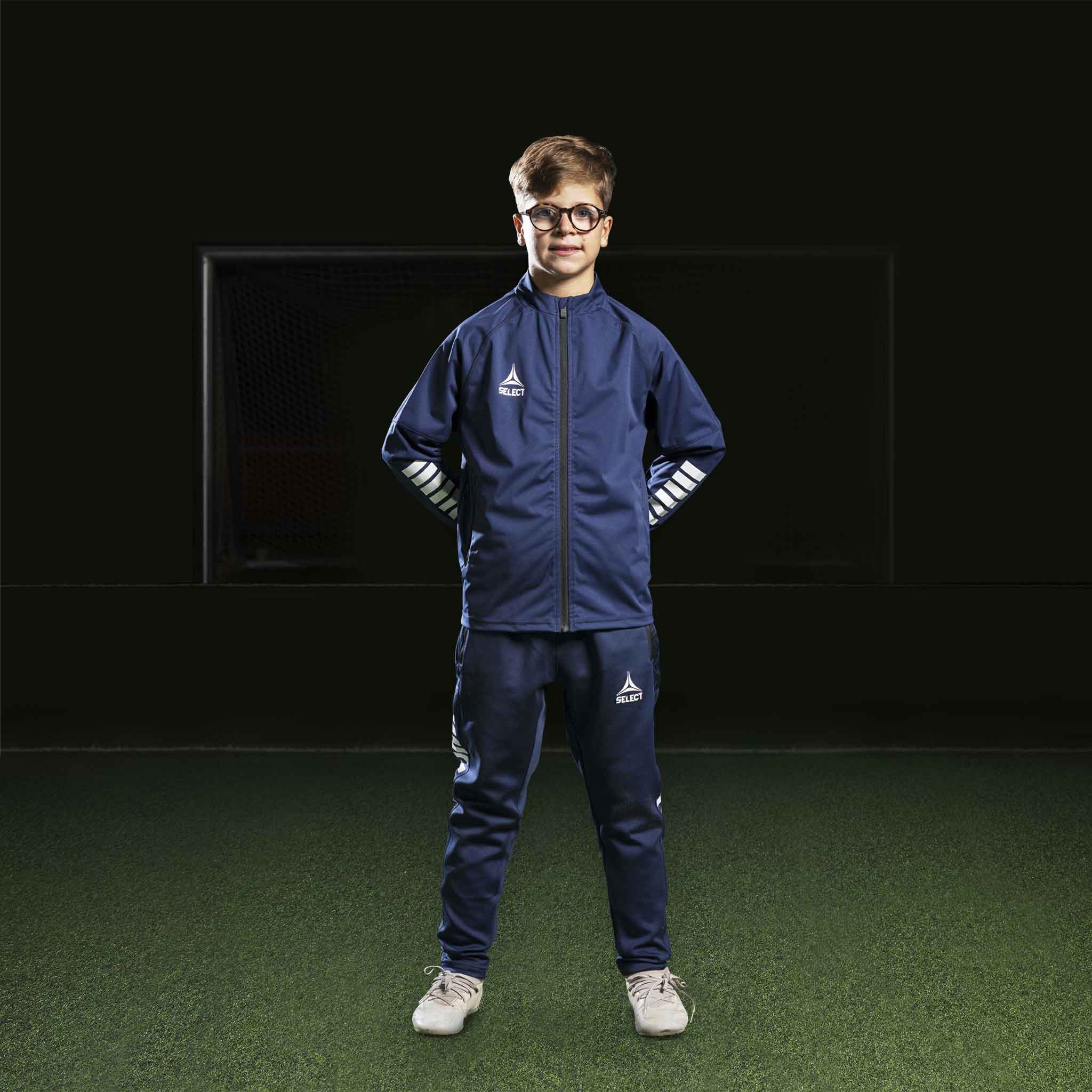 Boy football player in navy and white Zip jacket Monaco v24, Match & Training wear, front view.