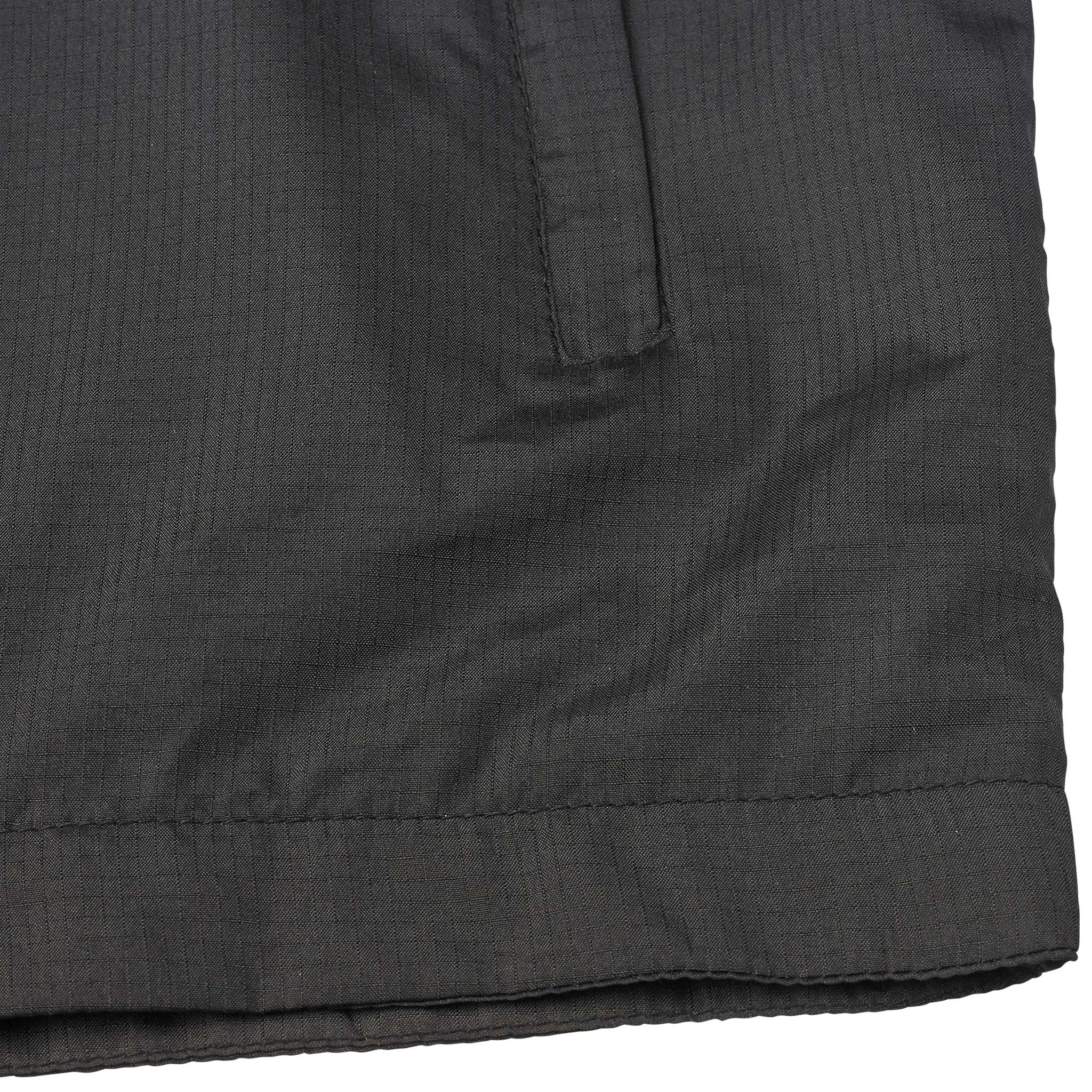 Closeup of black Training jacket Spain v25, Match & Training wear, showing hem and side pocket detail.