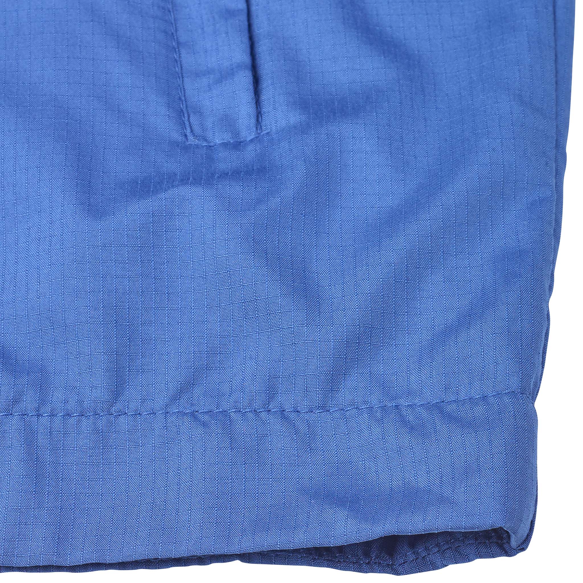 Closeup of blue Training jacket Spain v25, Match & Training wear, showing textured fabric and hem.