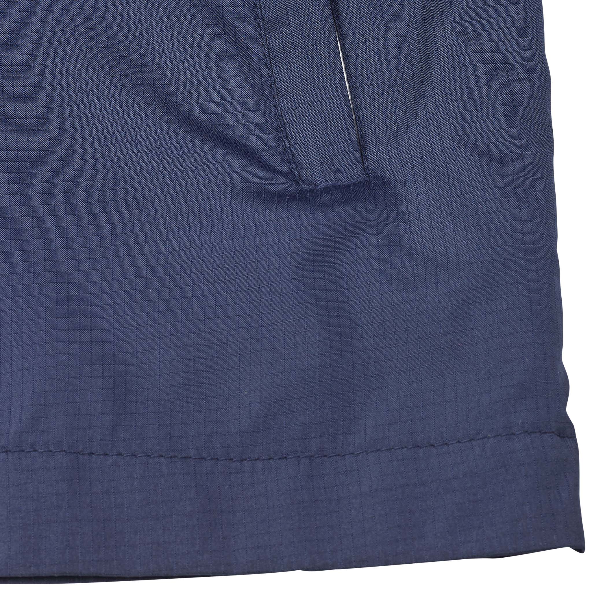 Closeup of navy Training jacket Spain v25, Match & Training wear, showing textured fabric, seams and pocket detail.
