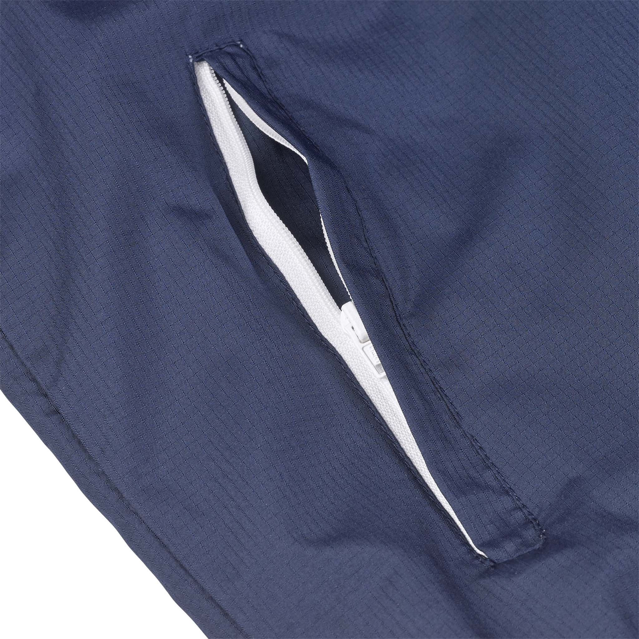Closeup of navy Training jacket Spain v25 zip pocket with white zipper, Match & Training wear