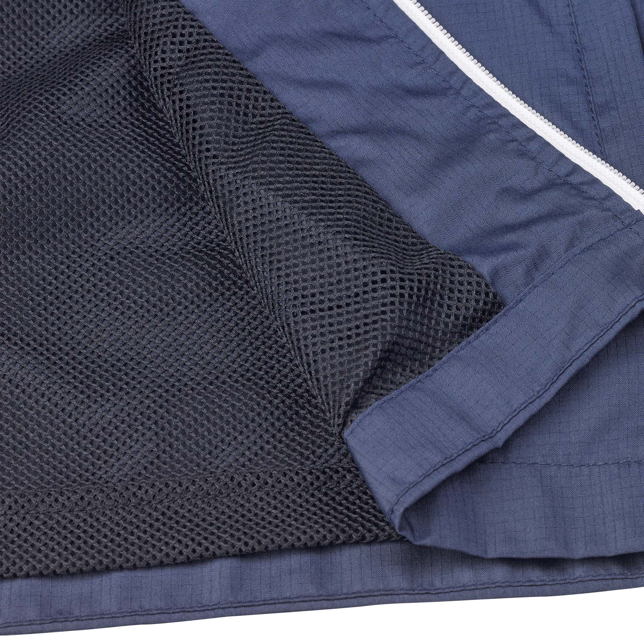 Closeup of navy Training jacket Spain v25, Match & Training wear, showing mesh lining and white-trimmed zipper.