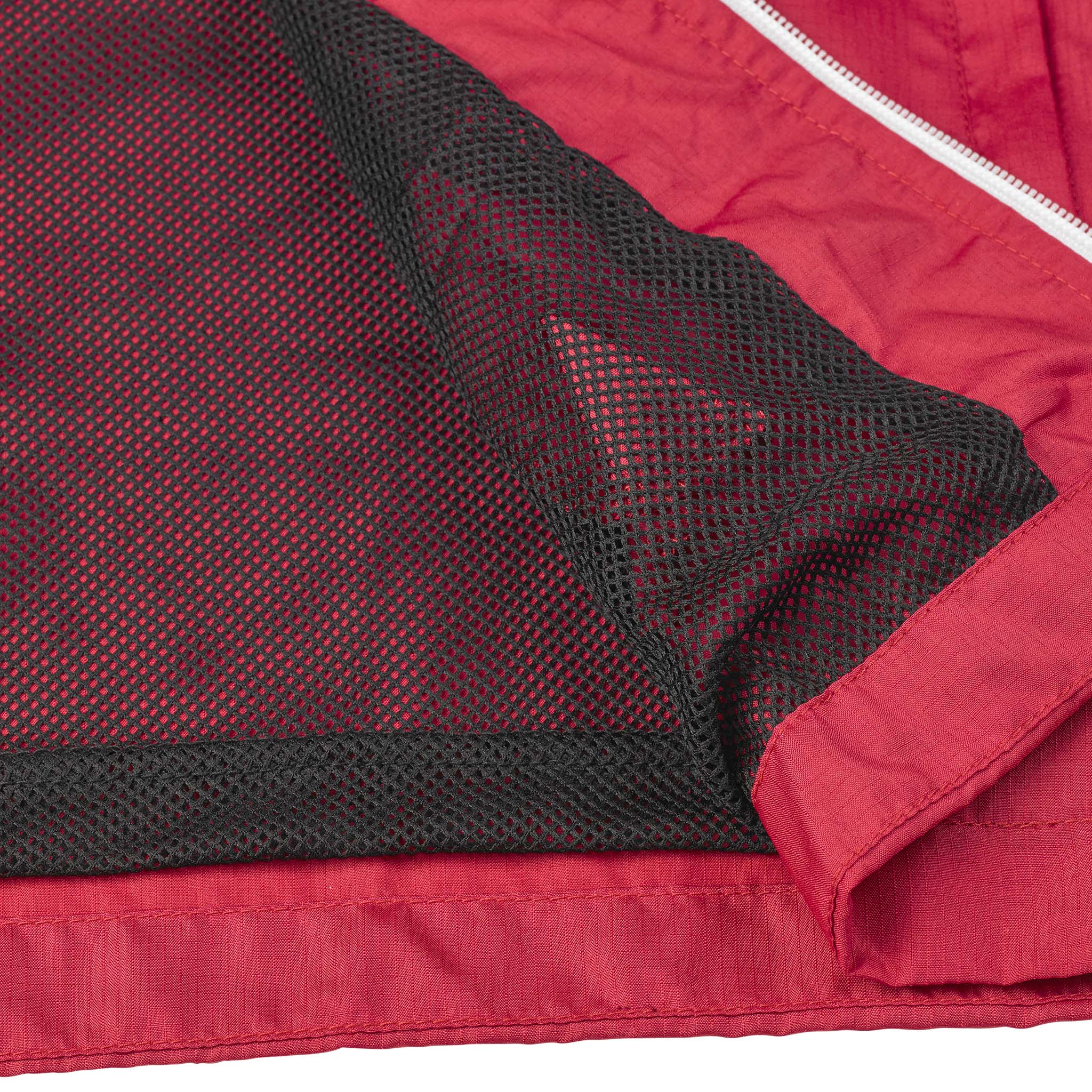 Closeup of red Training jacket Spain v25, black mesh lining, white zipper. Match & Training wear.