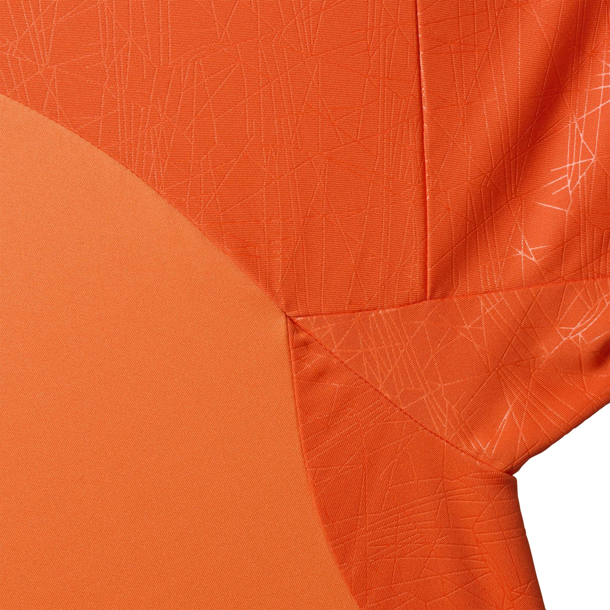 Closeup of Player shirt S/S Spain v25, Match & Training wear, in orange with subtle textured pattern.
