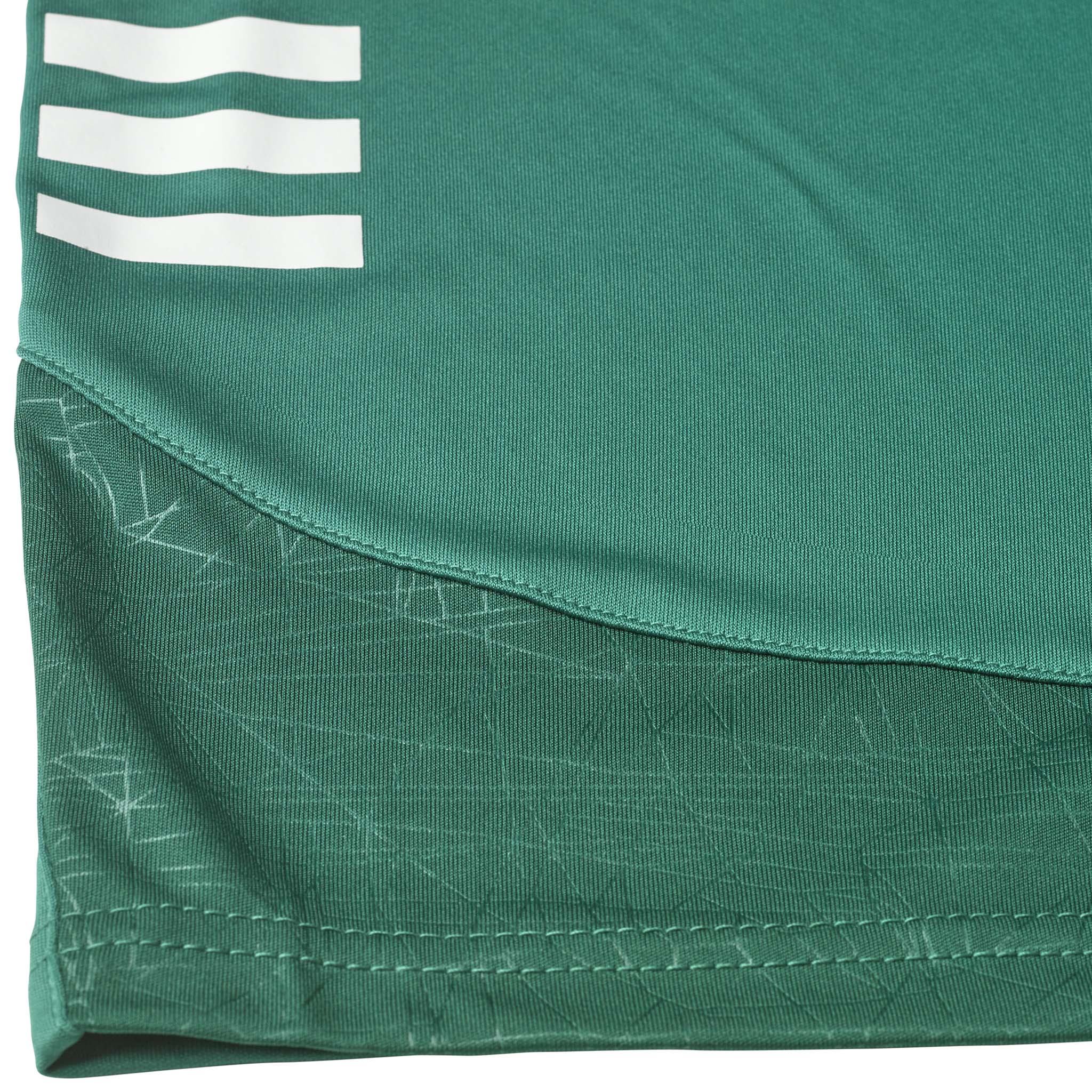 Closeup of green Player shorts Spain v25, Match & Training wear, with white stripes and patterned fabric detail.