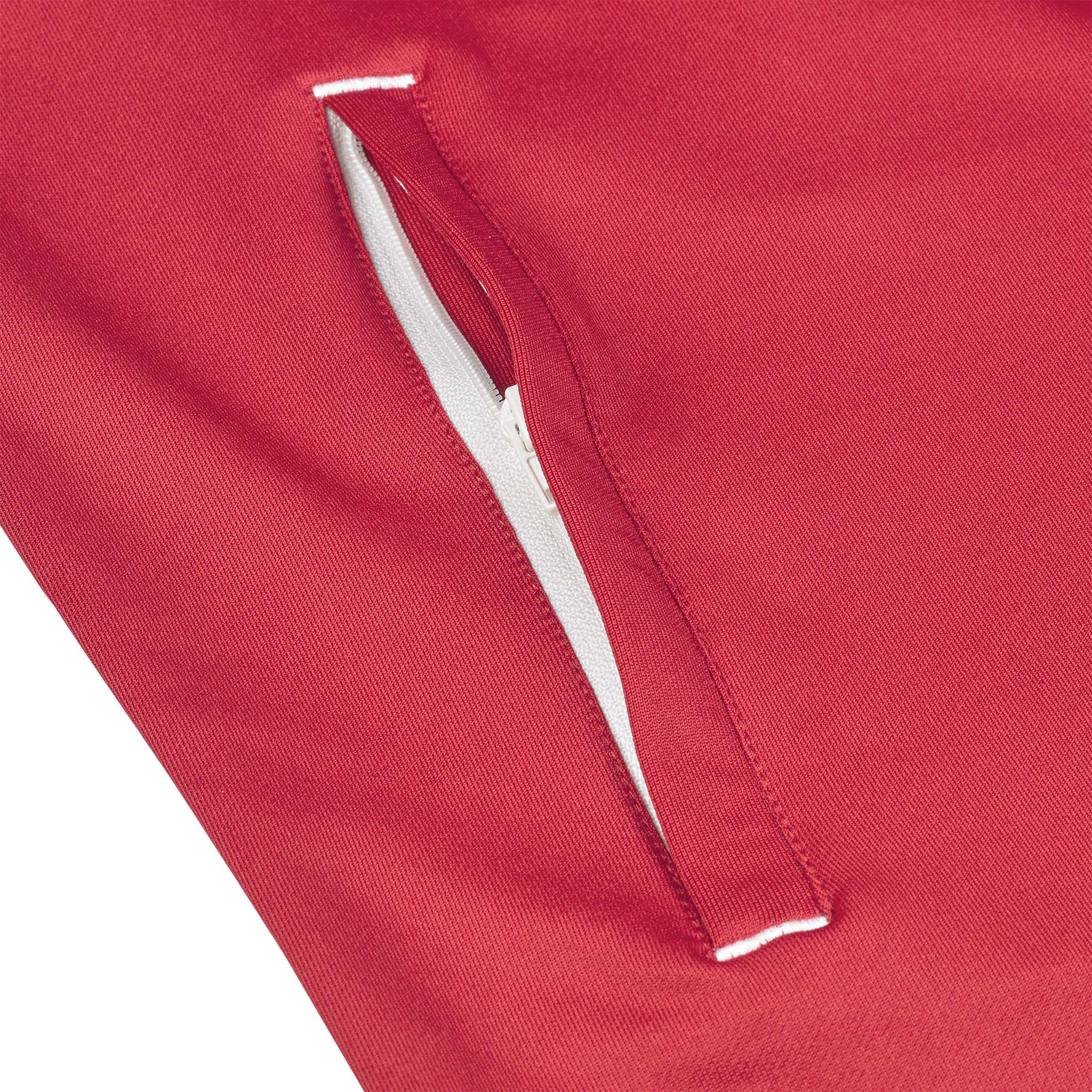 Closeup of red Training zip jacket Spain v25, white-trimmed zip pocket, Match & Training wear
