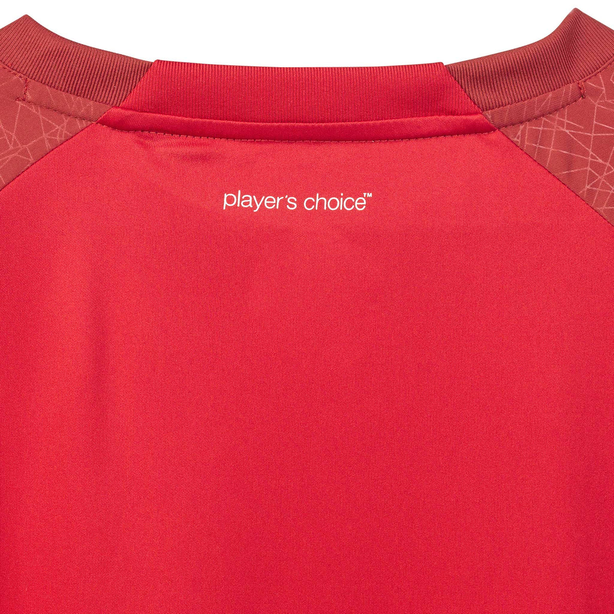 Closeup of red Player shirt S/S Spain woman v25, Match & Training wear, with white "player's choice" print and patterned shoulders.
