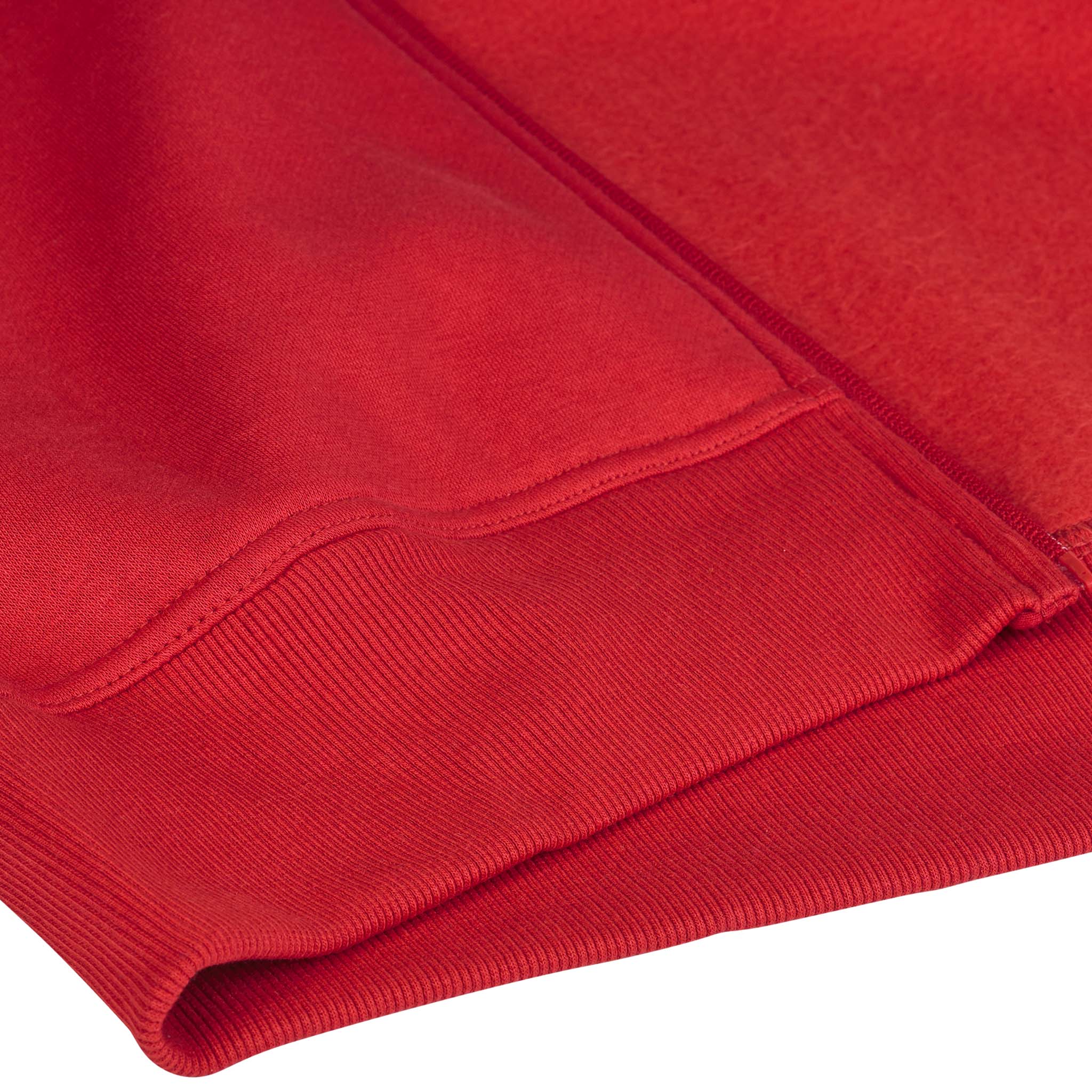 Closeup of red Zip hoodie Oxford v25 leisure wear, showing ribbed cuff and soft fabric detail.