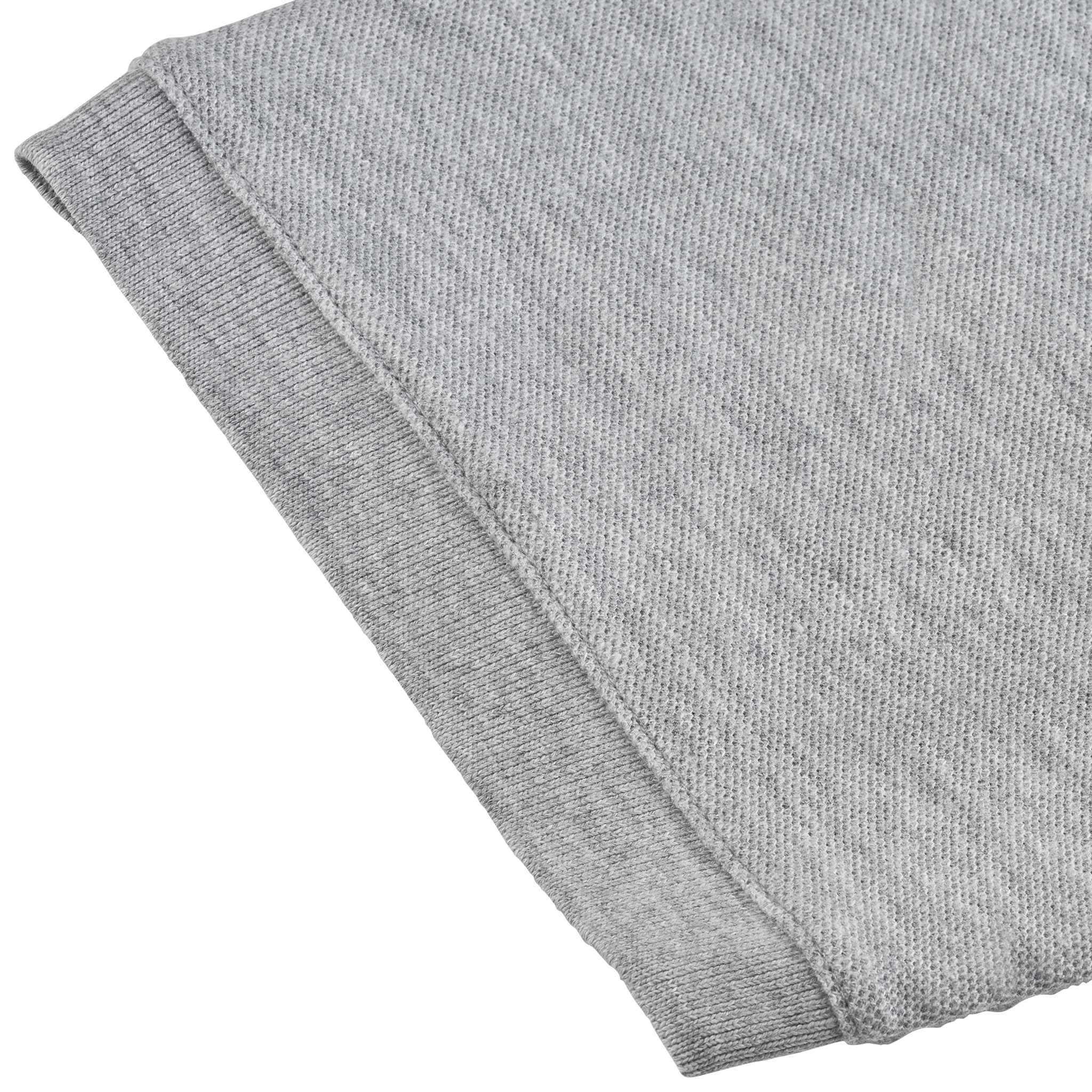 Closeup of grey Polo t-shirt Oxford v25, leisure wear, showing ribbed knit hem and fabric texture.