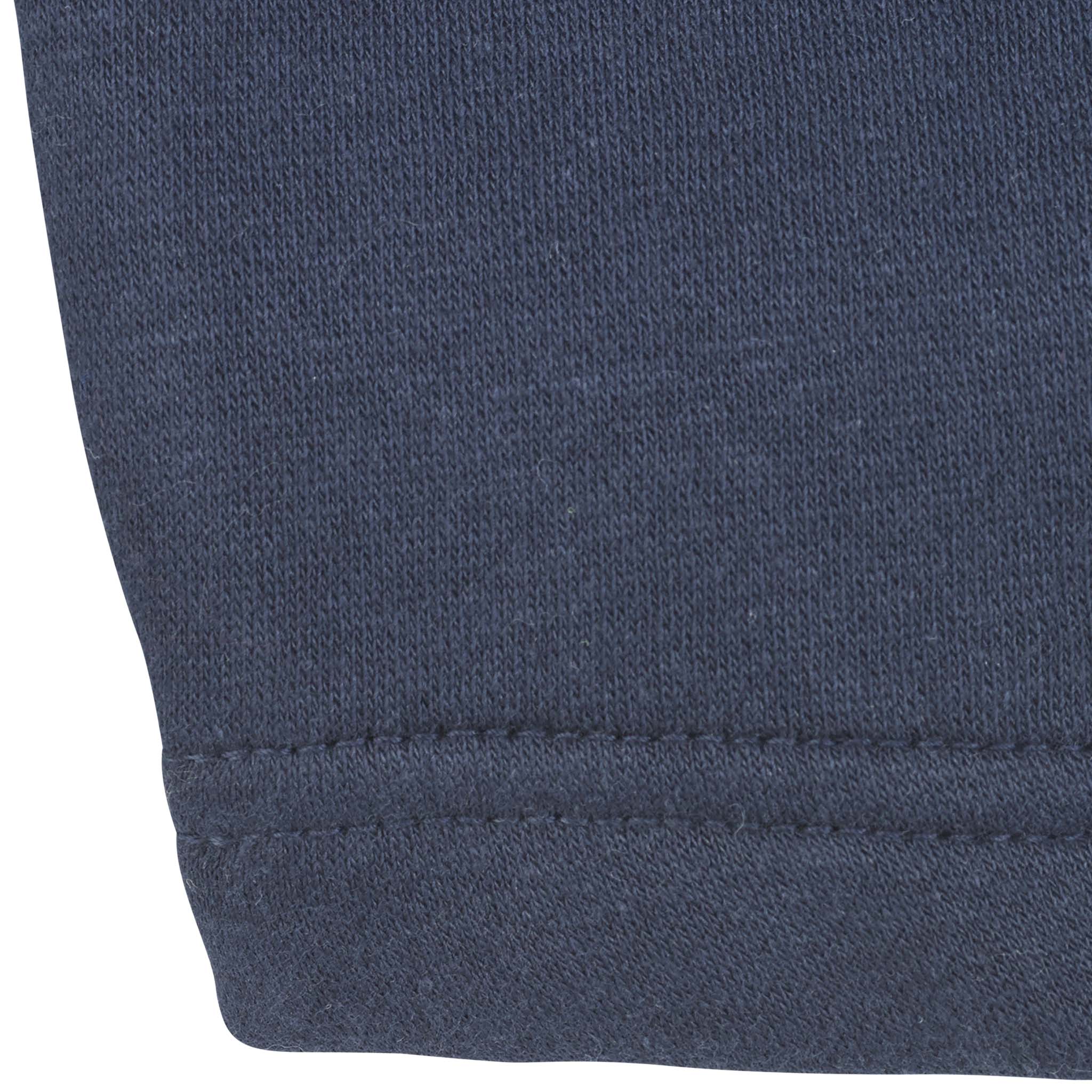 Closeup of navy Zip jacket Oxford v25 leisure wear, showing the ribbed cuff and seam detail.