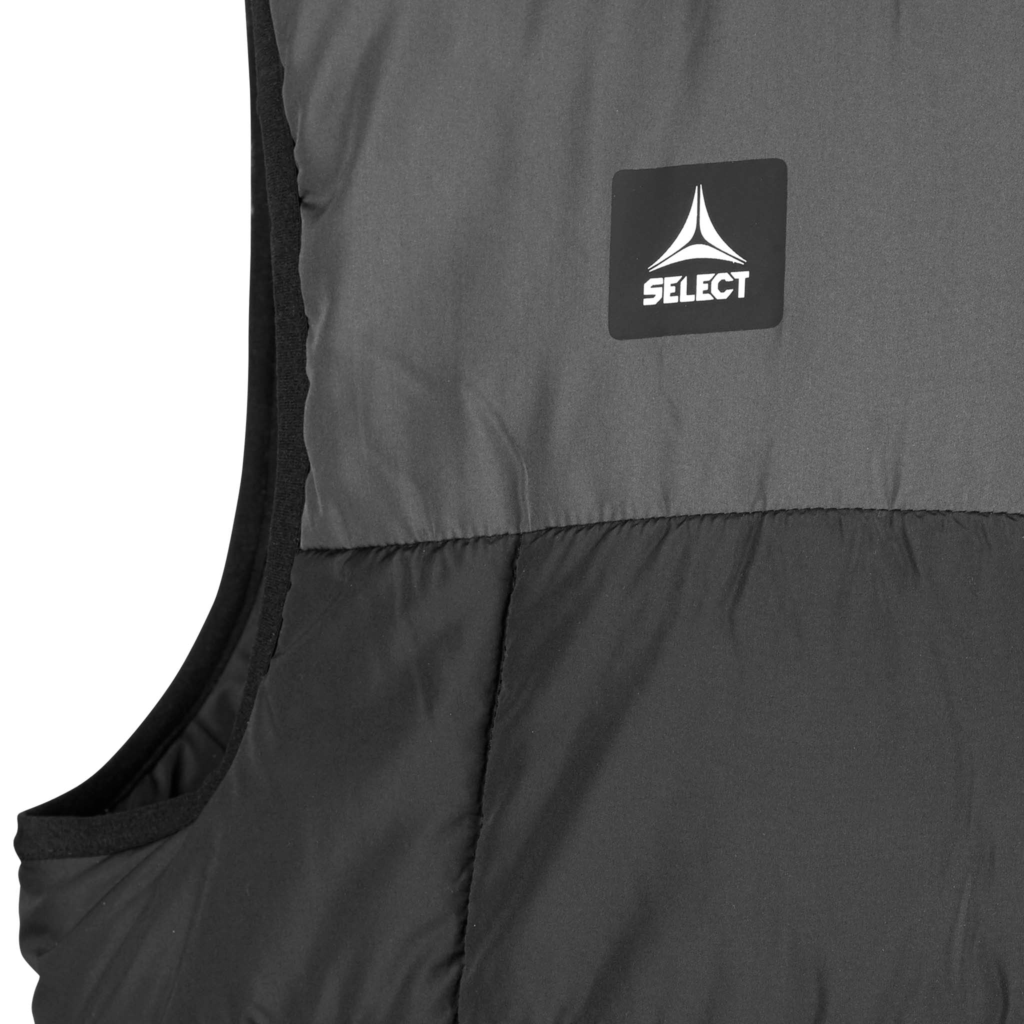 Closeup of Padded vest Oxford v25 leisure wear, showing grey and black quilted fabric with logo patch.
