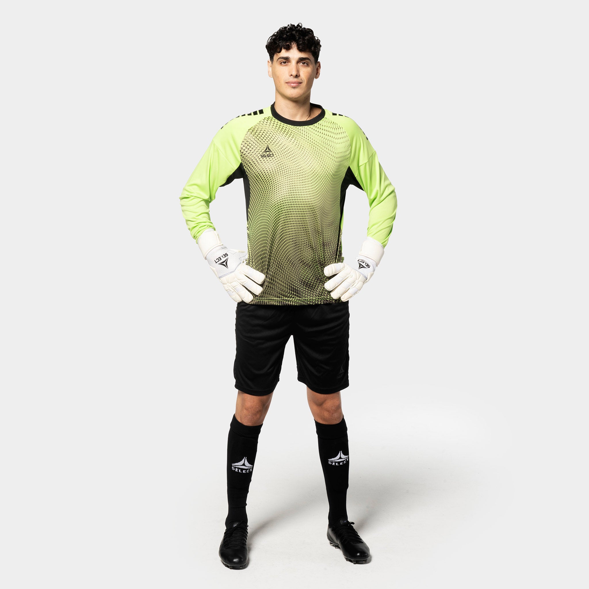 Male football player in lime green and black Goalkeeper shirt Spain v25, goalkeeper wear, front view with black shorts and gloves.