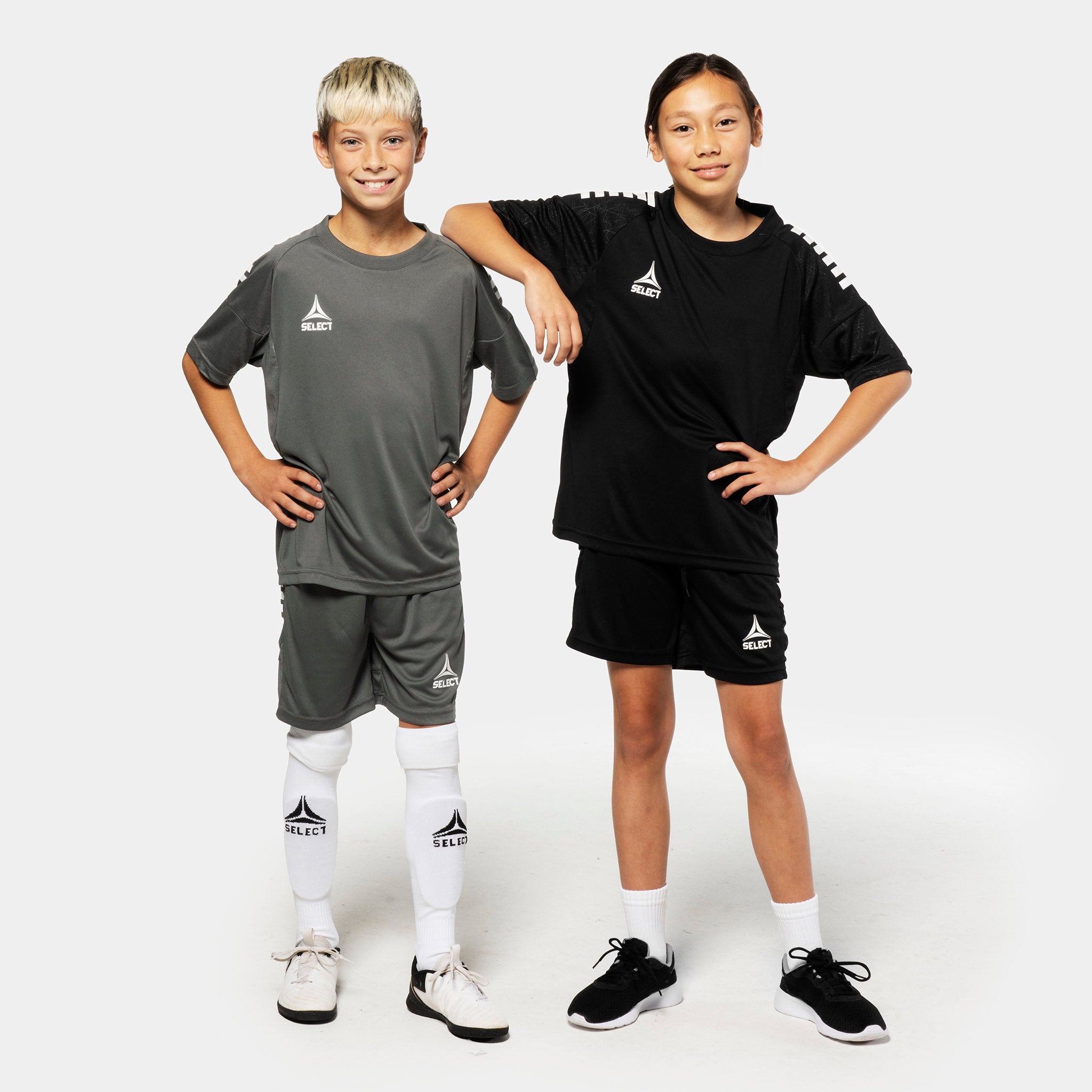 Young football players wearing Player shorts Spain v25 in grey and black, Match & Training wear, front view.