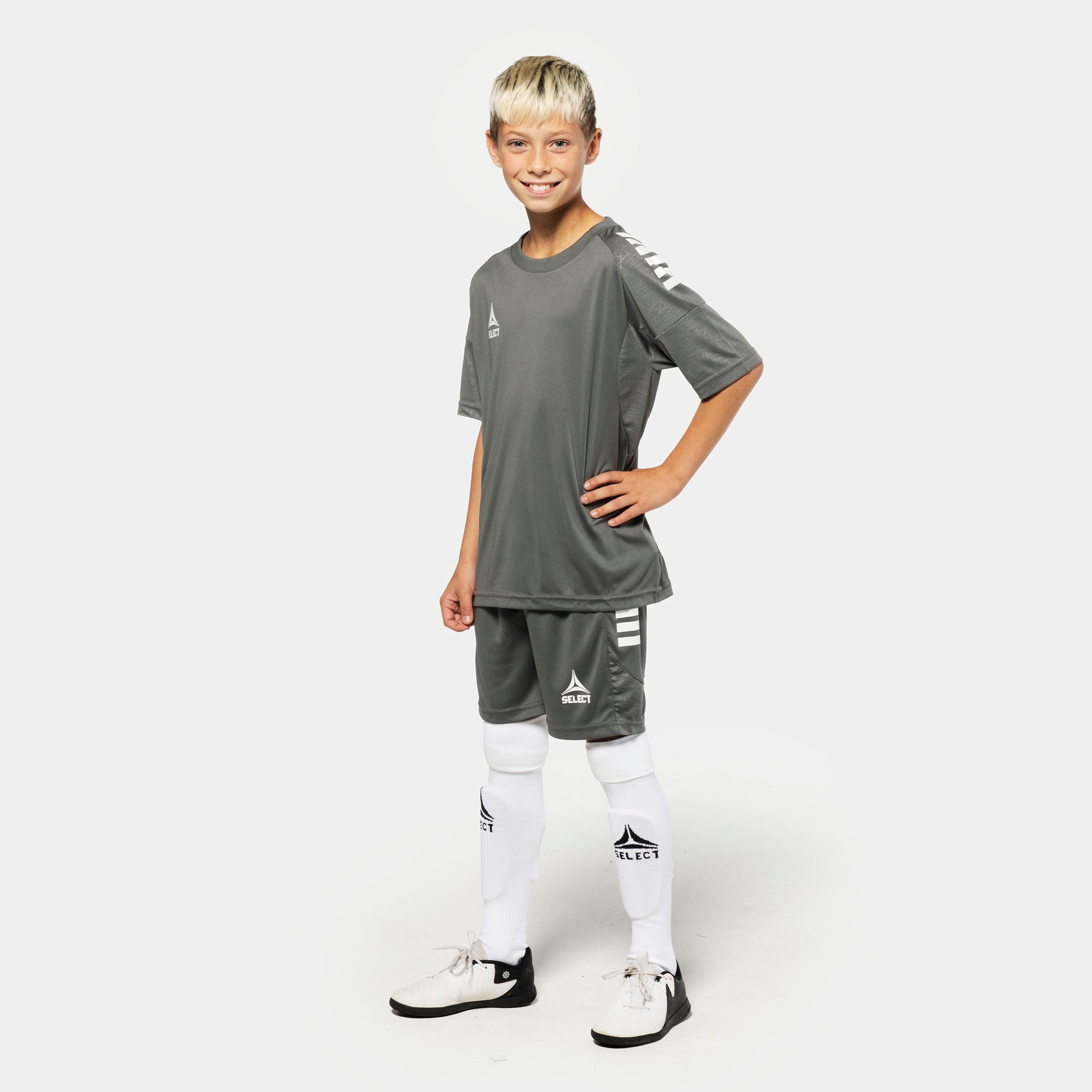 Boy football player in grey Player shorts Spain v25 and matching shirt, Match & Training wear, front view.