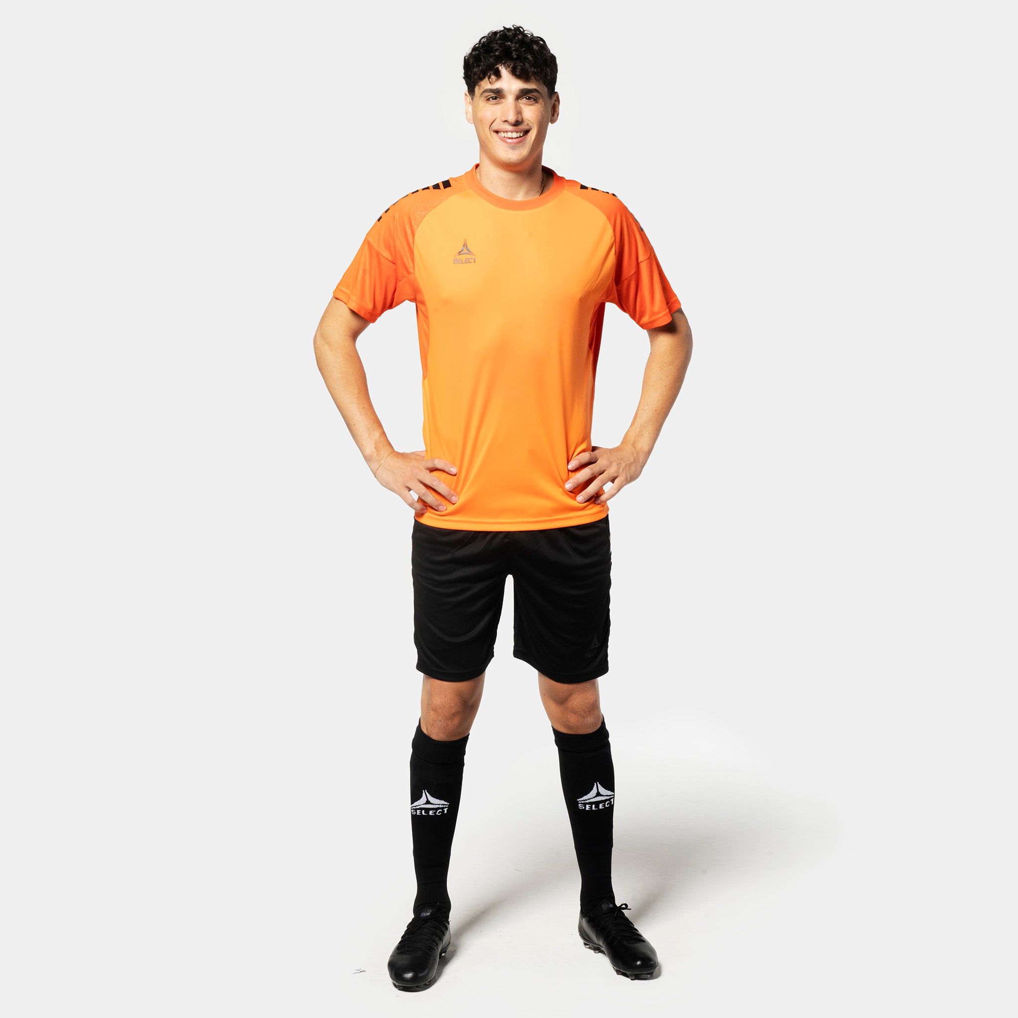 Man football player in orange shirt & black Player shorts Spain v25, Match & Training wear, front view
