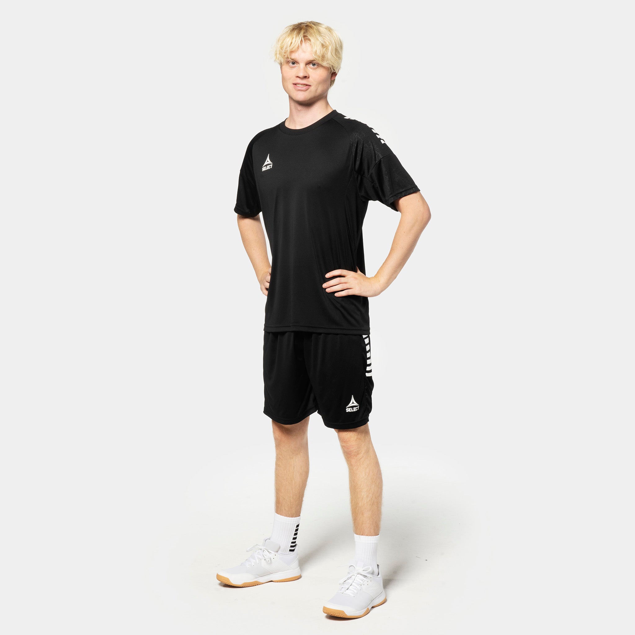 Male football player in black Player shorts Spain v25 and matching shirt, Match & Training wear, front view.