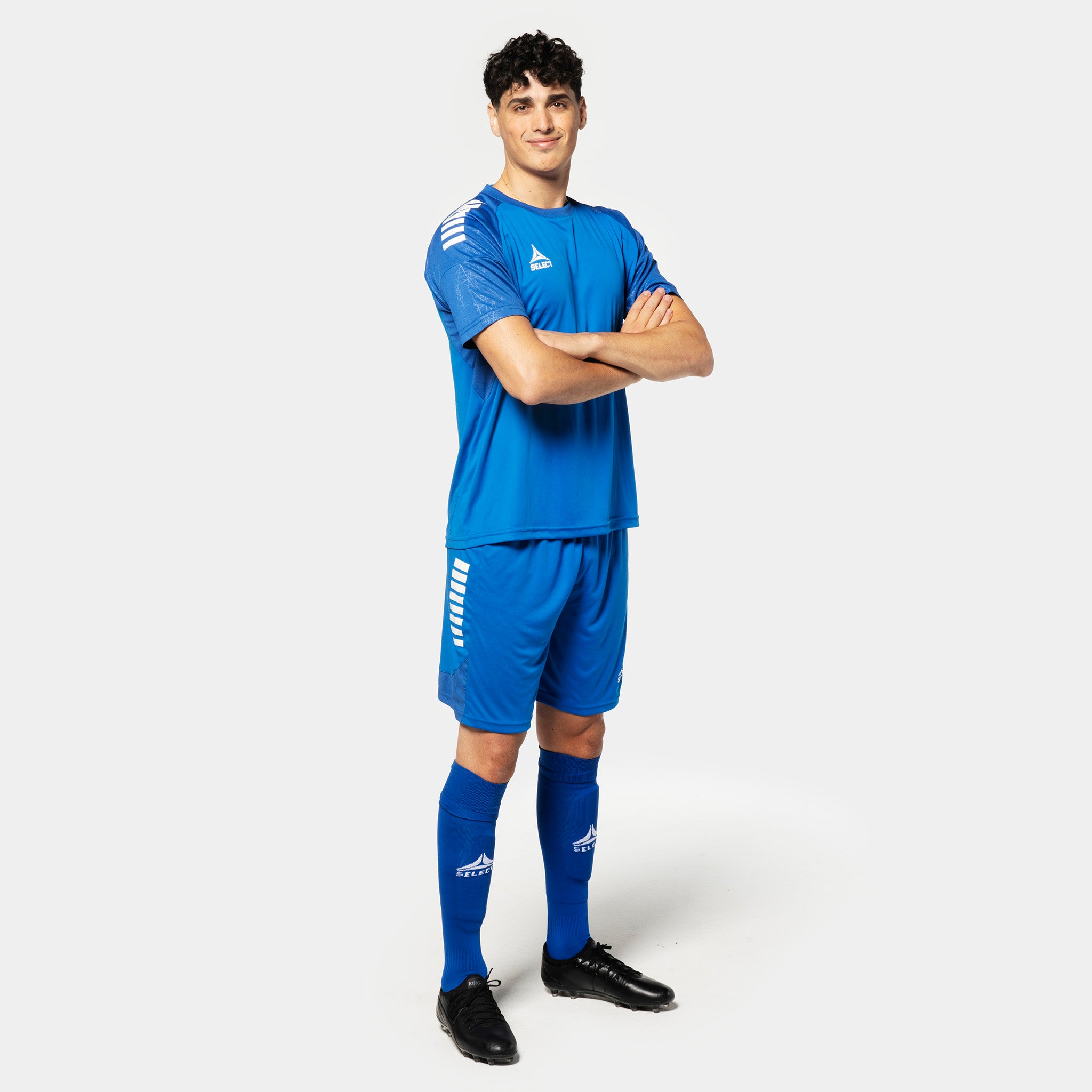 Male football player in blue Player shorts Spain v25, Match & Training wear, with white side stripes.