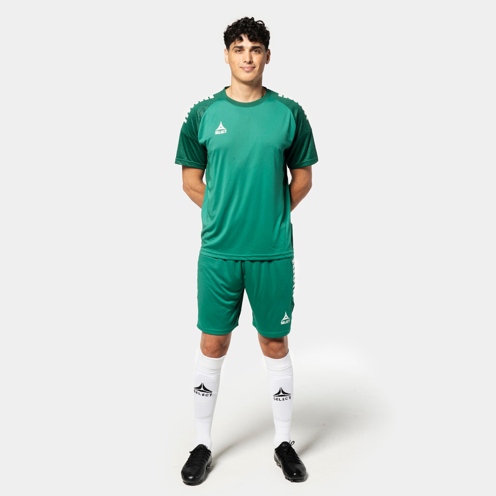 Male football player in green Player shorts Spain v25, Match & Training wear, with matching shirt and socks.