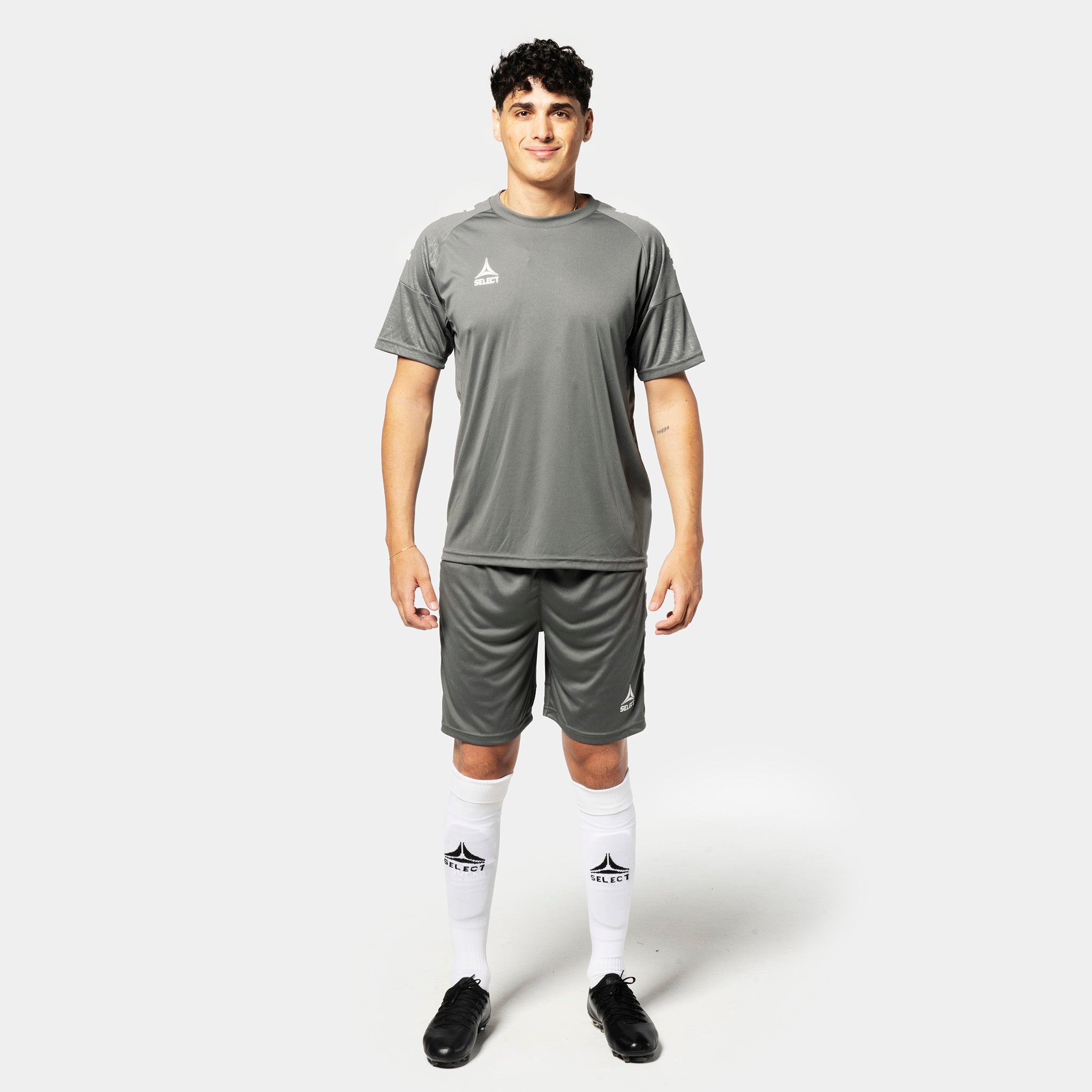 Male football player in grey Player shorts Spain v25 and matching shirt, Match & Training wear, front view.