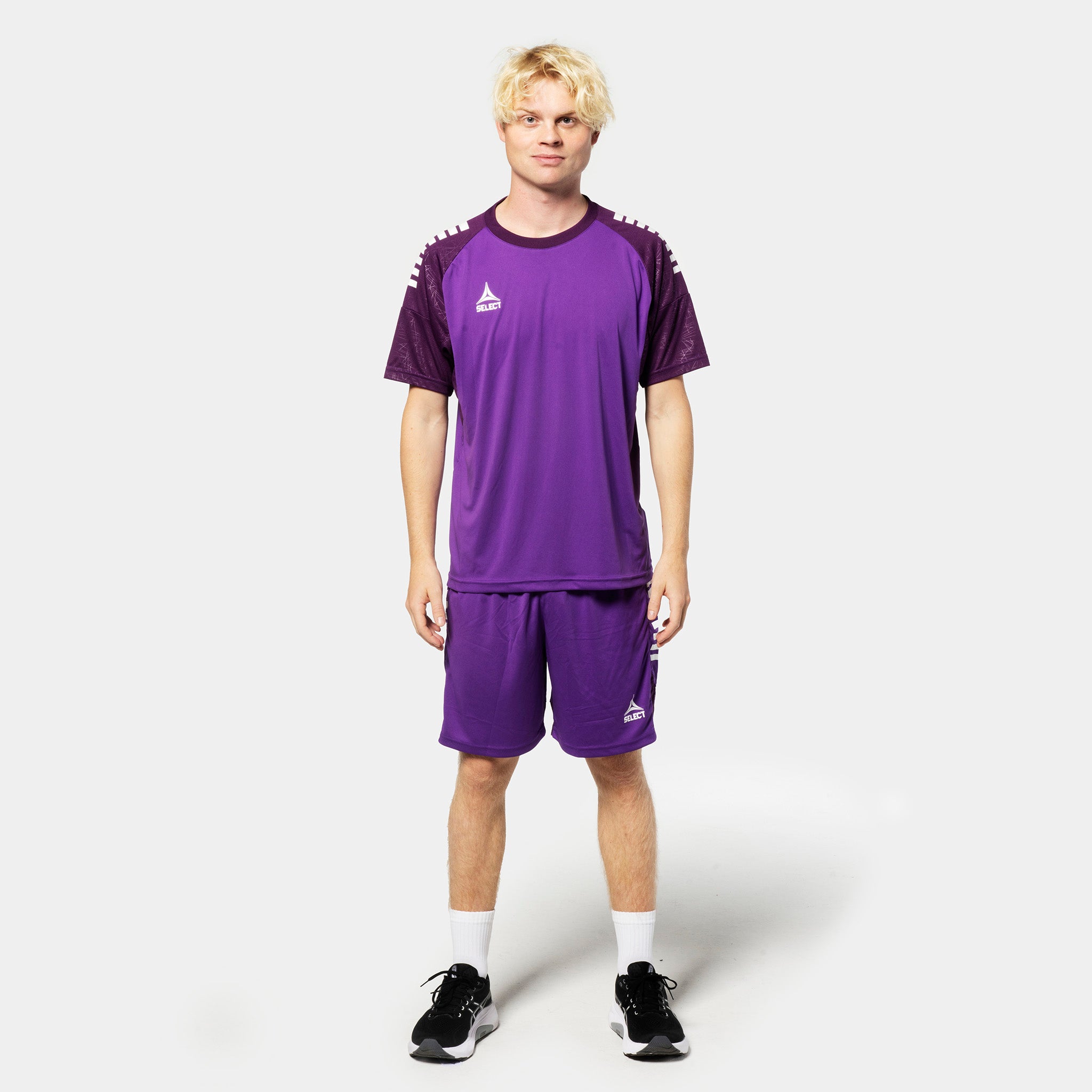 Male football player in purple Player shorts Spain v25 and matching shirt, Match & Training wear, front view.