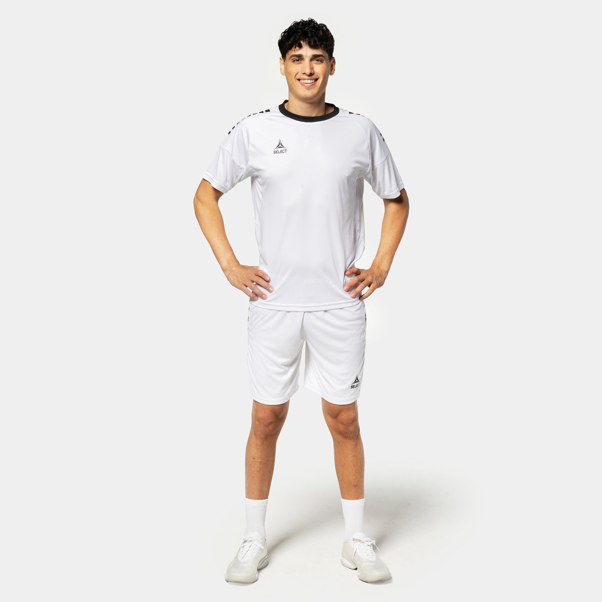 Male football player in white Player shorts Spain v25 and matching shirt, Match & Training wear, front view.