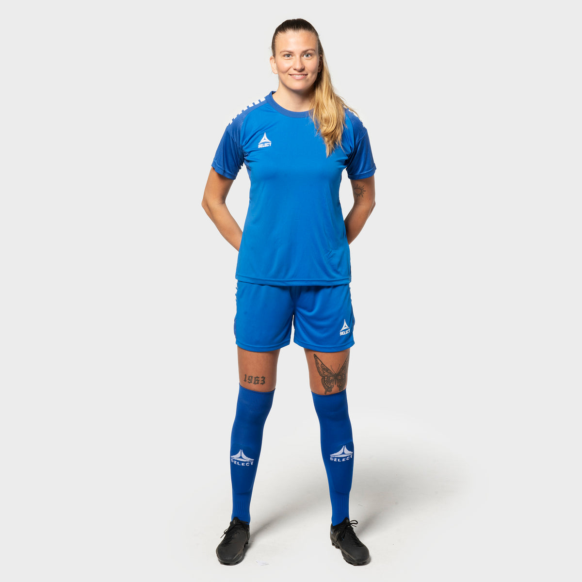 Woman football player in blue-white Spain v25 shirt and shorts, Match & Training wear, front view.