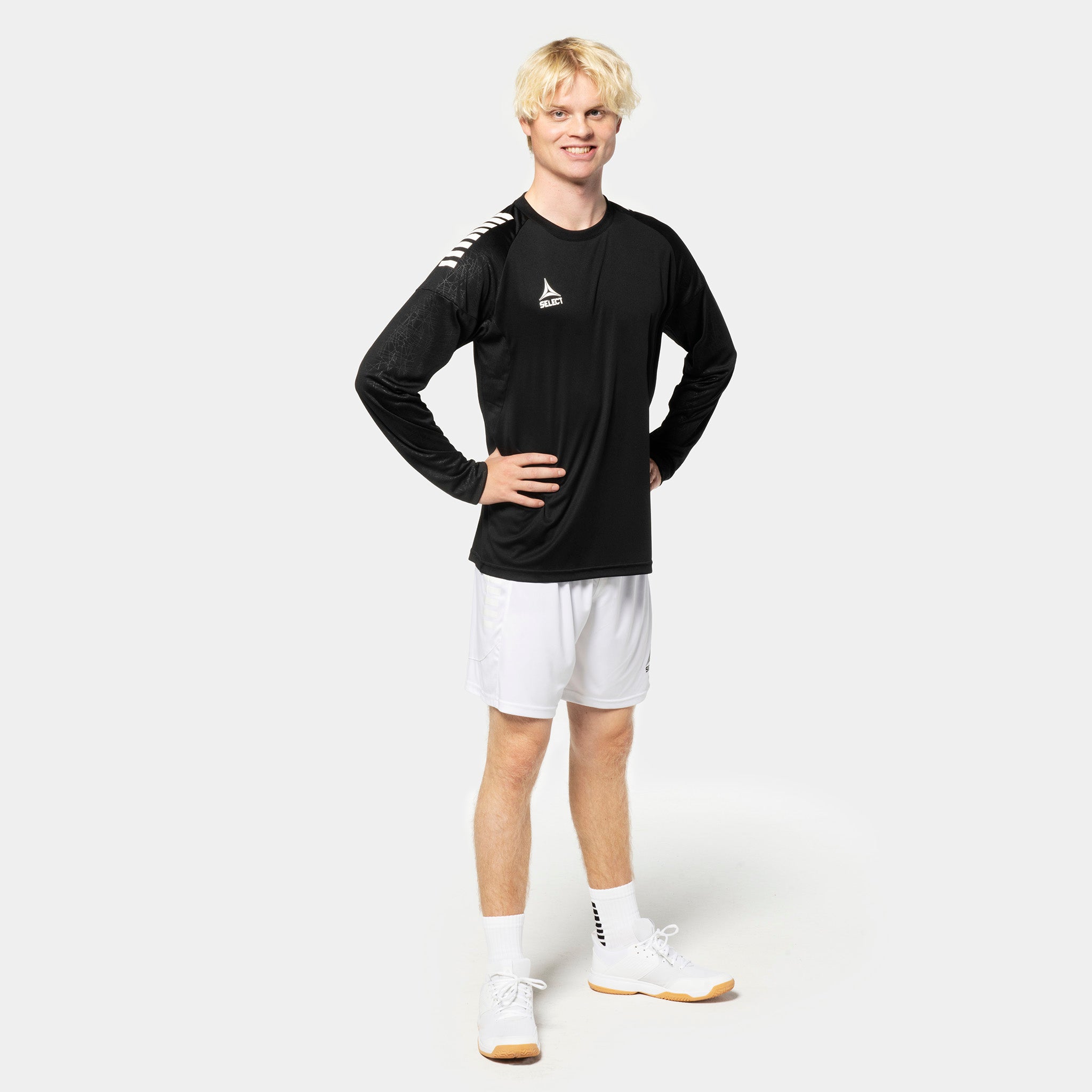 Man in black Player shirt L/S Spain v25, white shorts. Match & Training wear for football players.
