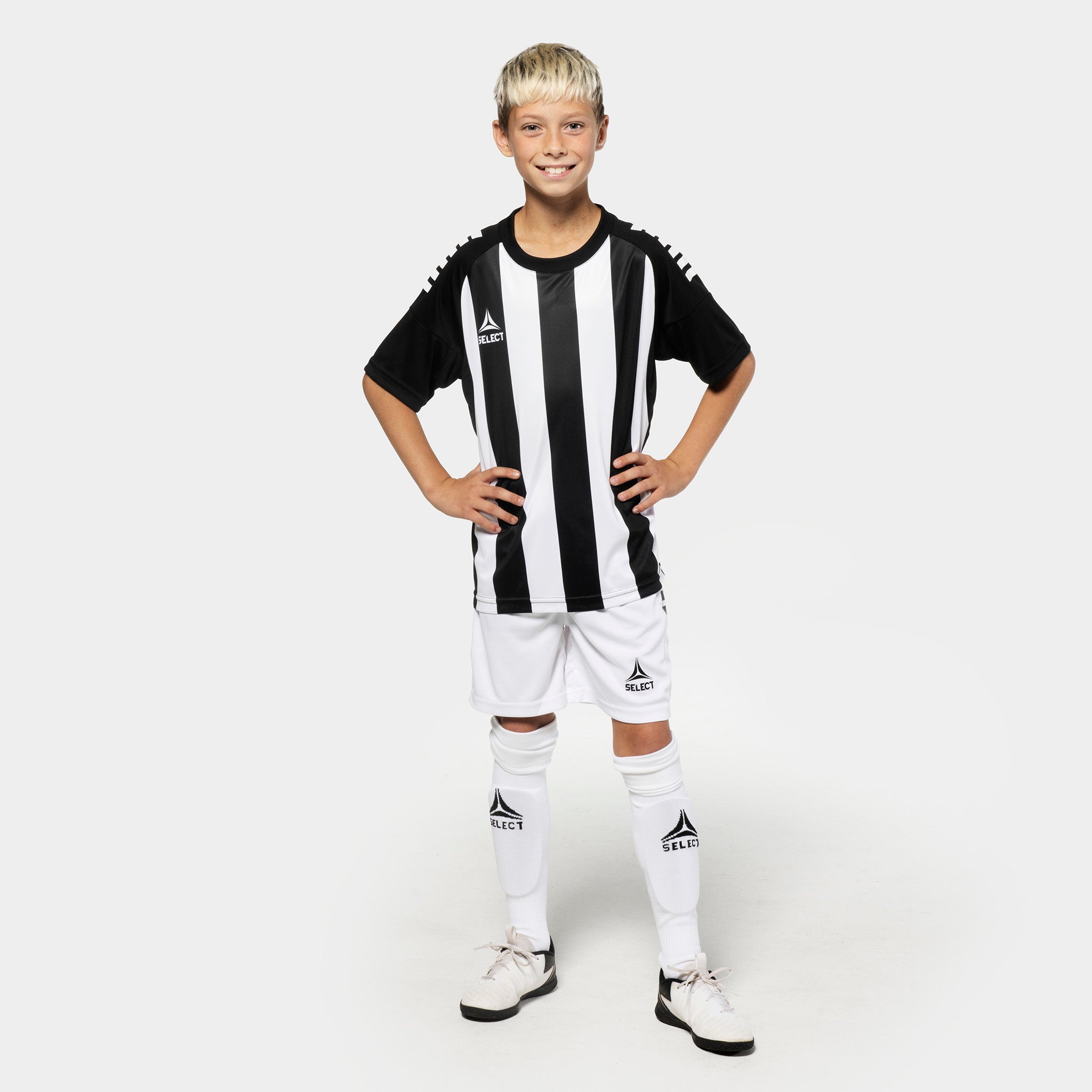 Boy football player in black-white striped Player shirt S/S Spain v25, Match & Training wear, with white shorts and socks.