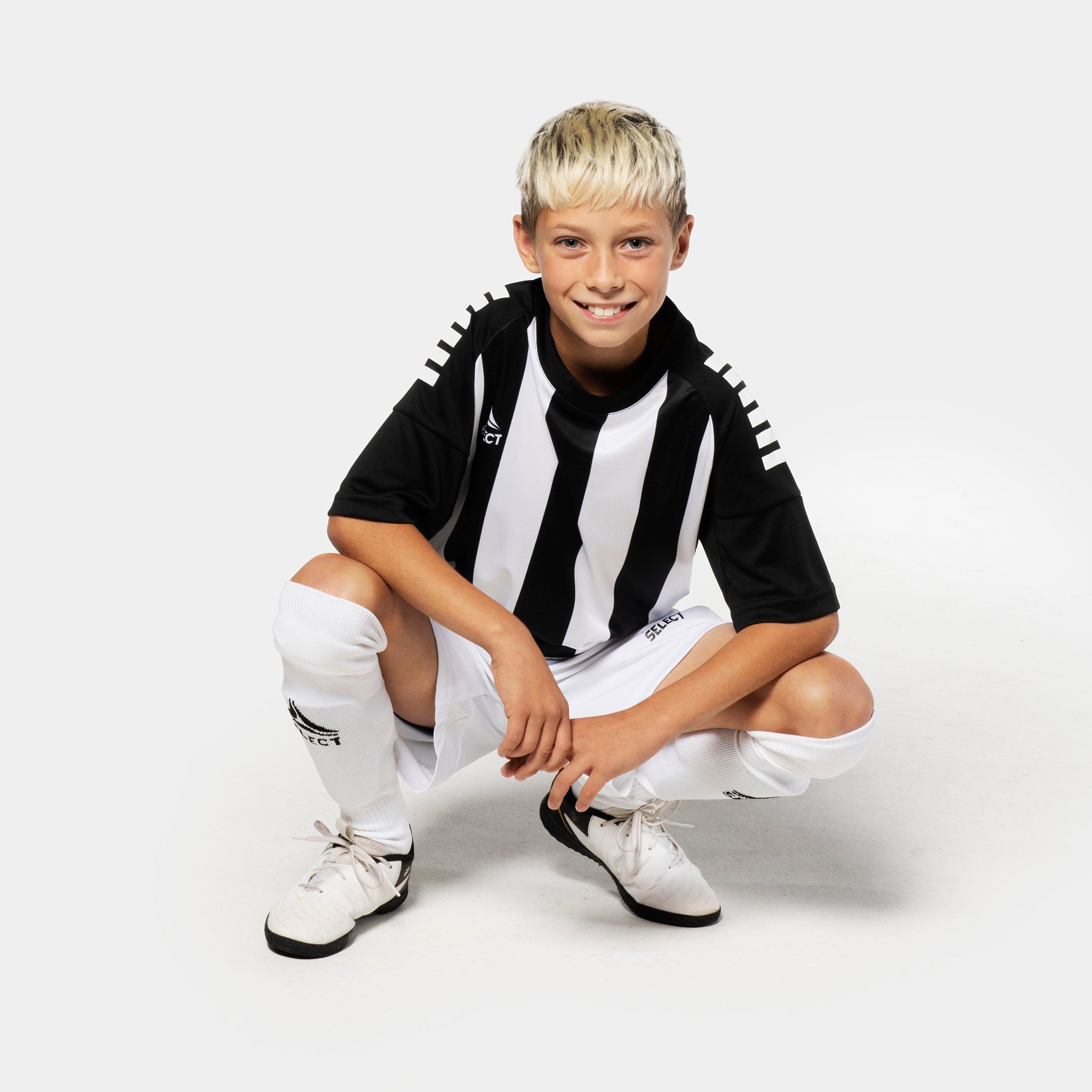 Boy football player wearing Player shirt S/S Spain striped v25, black/white Match & Training wear, front view