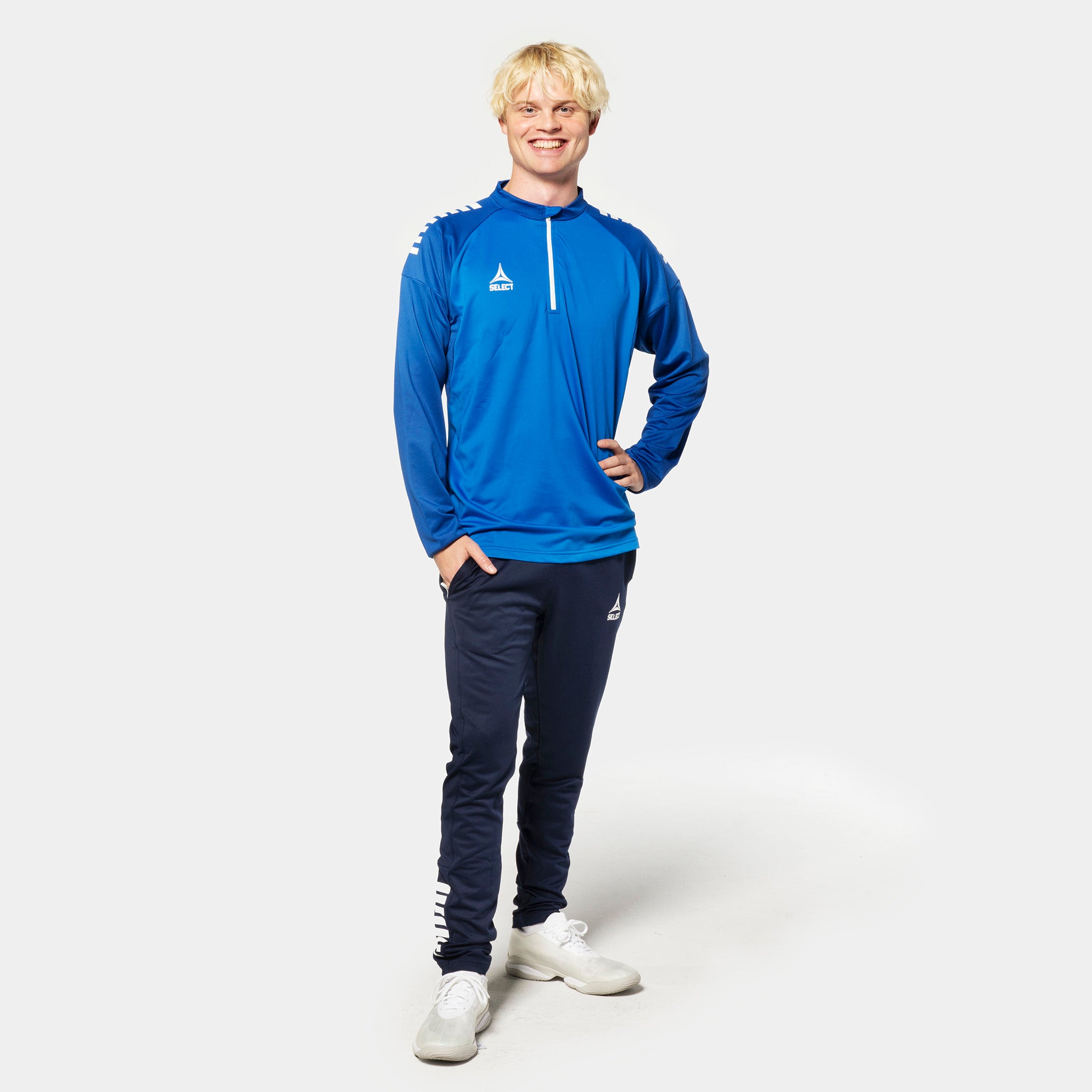 Man footballer in blue/white Training sweat 1/2 zip Spain v25, Match & Training wear, navy pants, front view