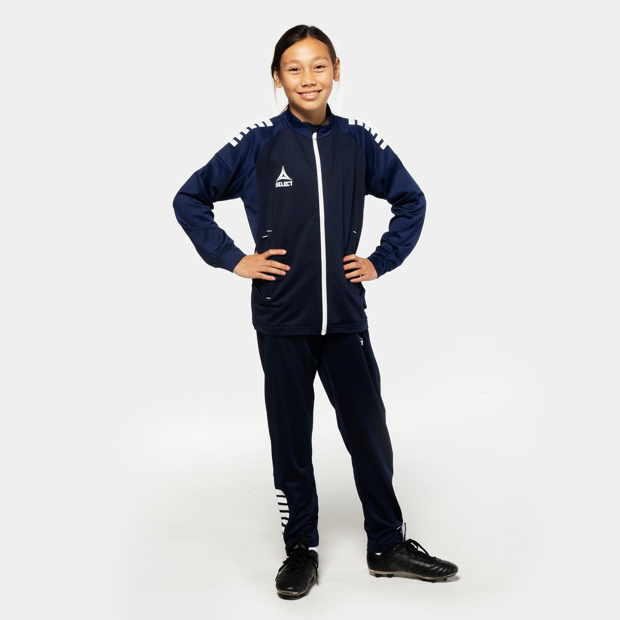 Girl footballer in navy Training zip jacket & pants regularFit Spain v25, Match & Training wear, front view
