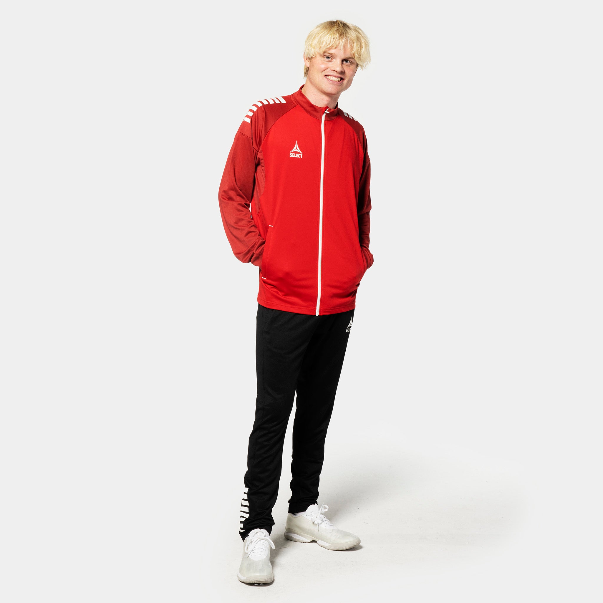 Male football player in red/white Training zip jacket Spain v25 and black pants, Match & Training wear.