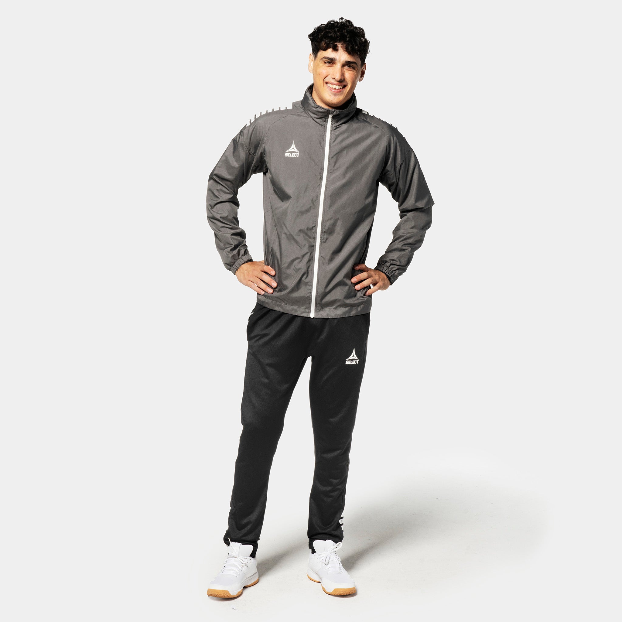 Male football player in grey and white Training jacket Spain v25 with black pants, Match & Training wear.