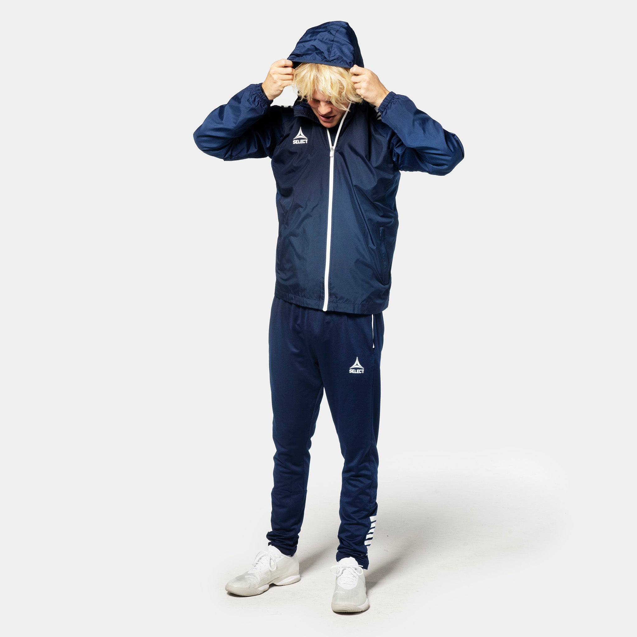Navy and white Training jacket Spain v25, Match & Training wear, worn by a male football player, front page view.