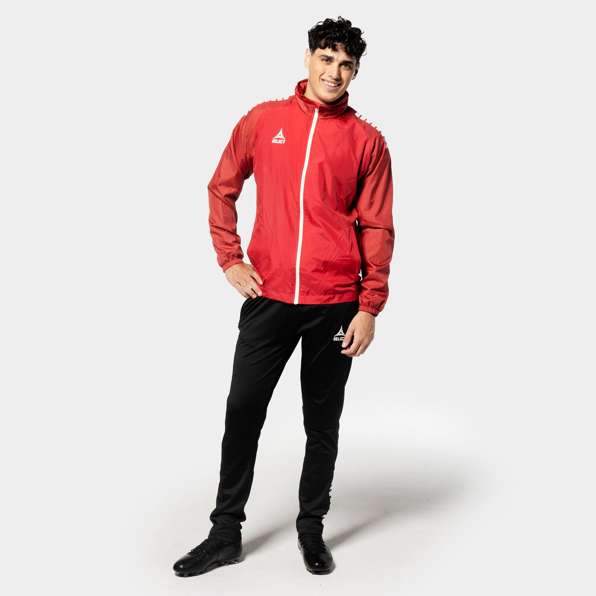Man footballer in red and white Training jacket Spain v25 with black pants, Match & Training wear