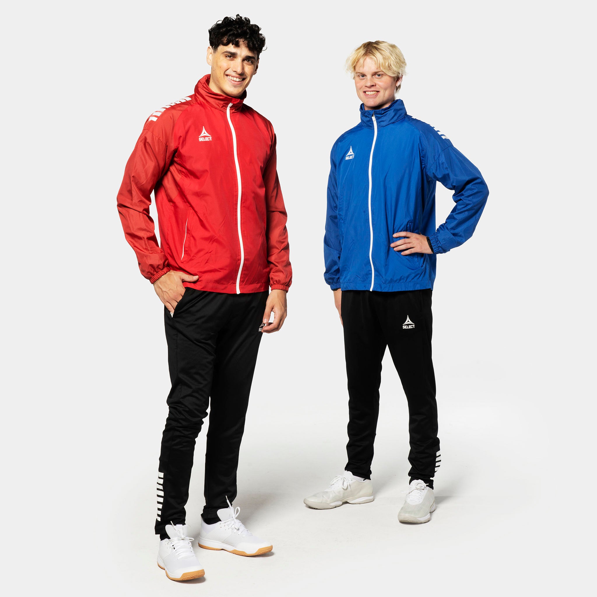 Two male football players model the Training jacket Spain v25 in red-white and blue-white, Match & Training wear.