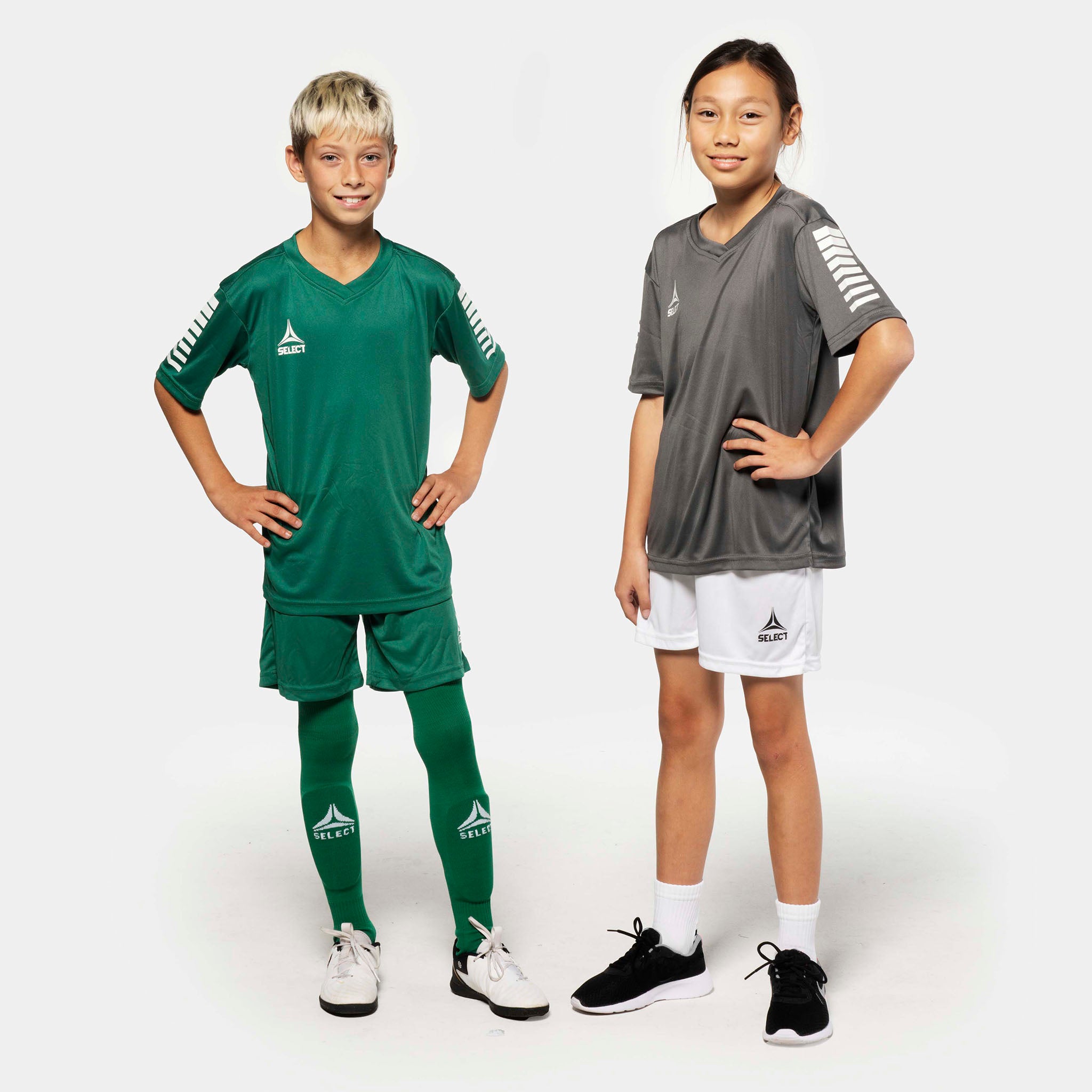 Boy football player in green Player shorts Pisa, girl in white. Match & Training wear, front view.