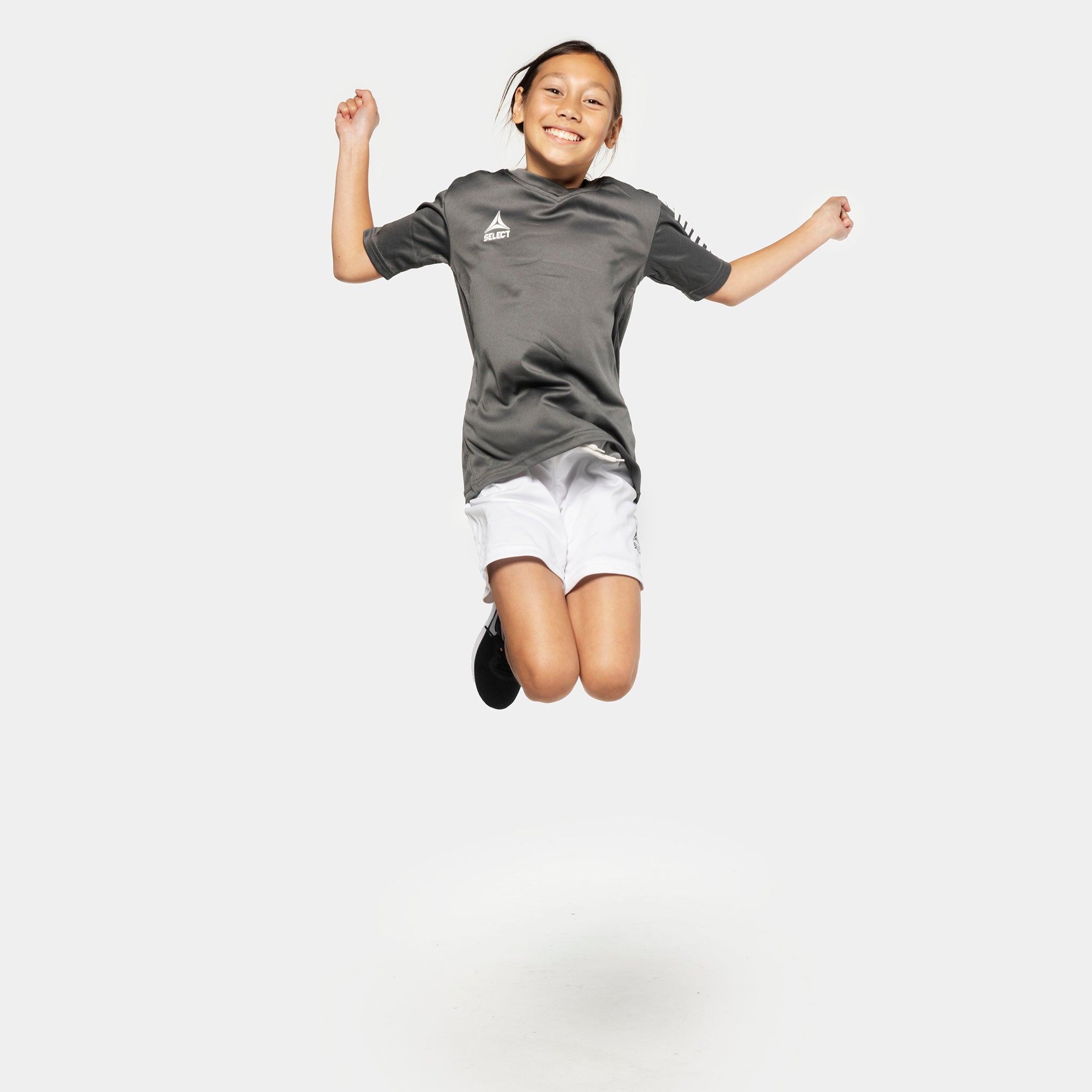 Boy football player jumping in grey shirt and white Player shorts Pisa, Match & Training wear.