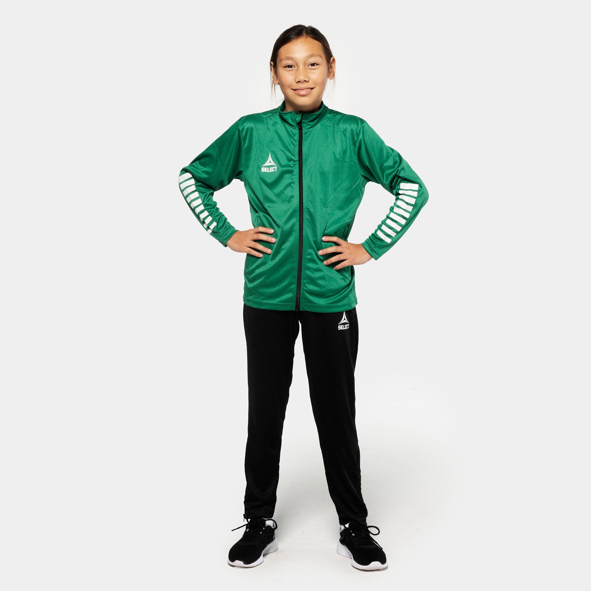 Girl football player in green zip jacket and black Training pants regular fit Pisa, Match & Training wear, front view.