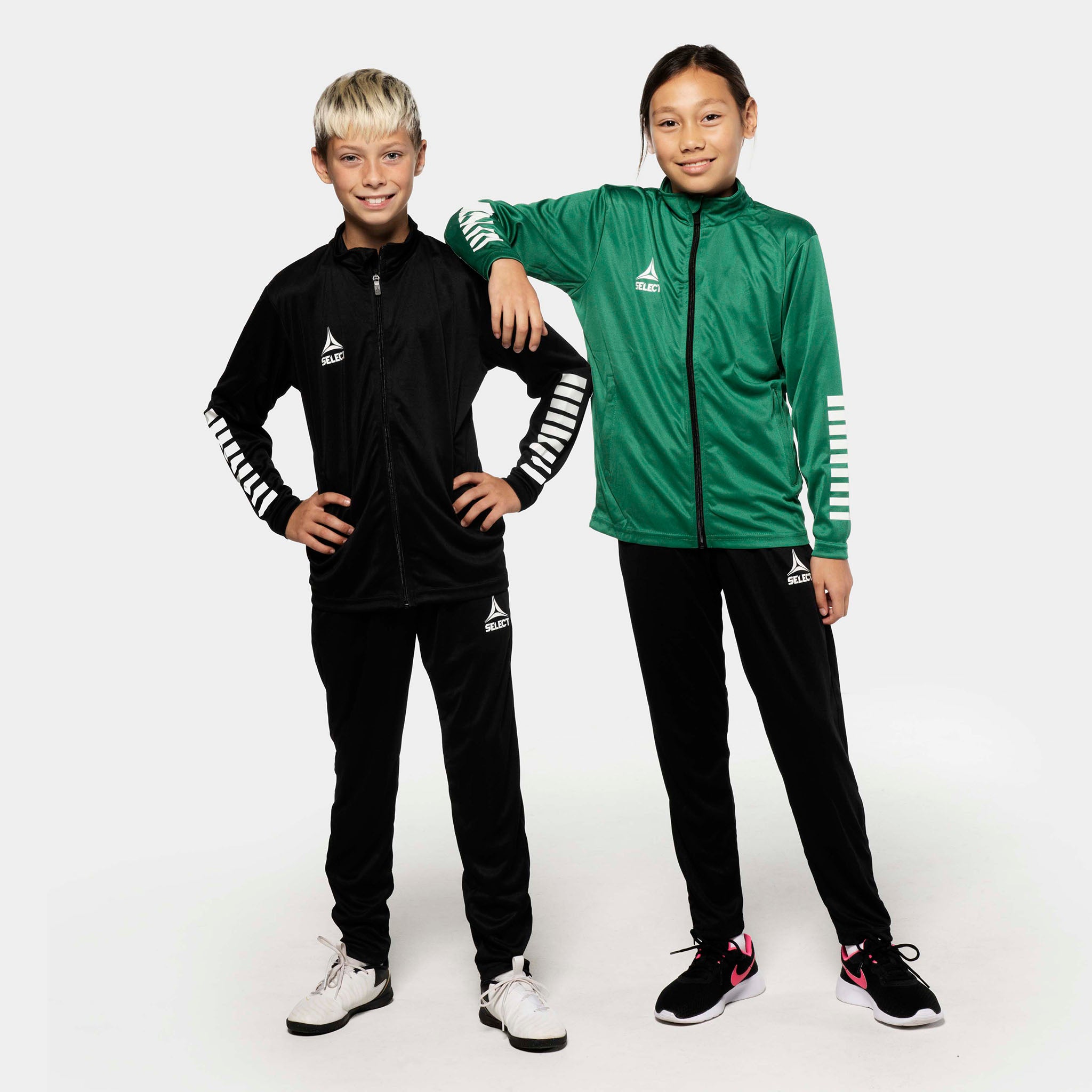 Boy and girl football players in black and green Training pants regular fit Pisa, Match & Training wear, front view.