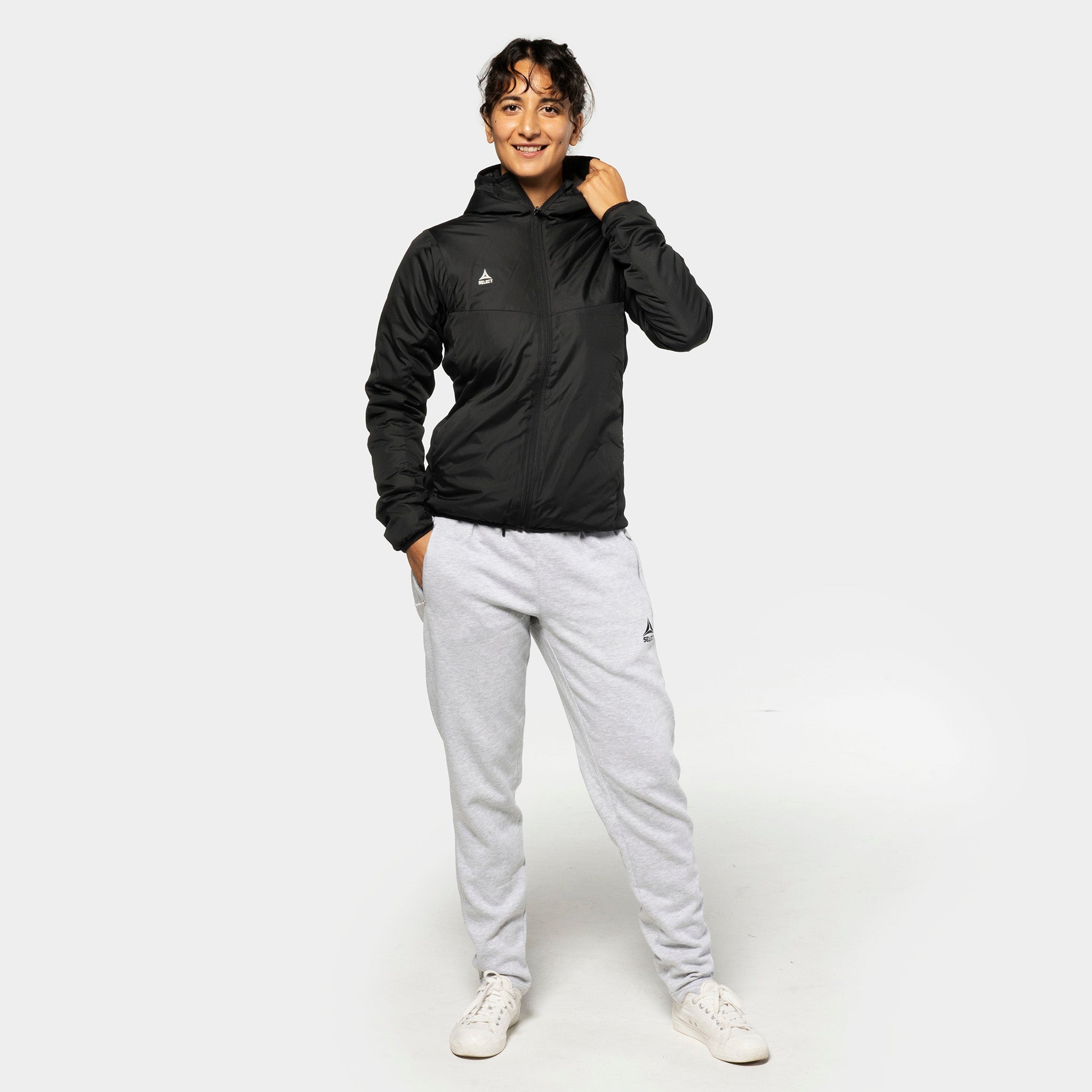 Woman football player in black hybrid jacket and grey Sweat pants Oxford women v25, leisure wear, front view.