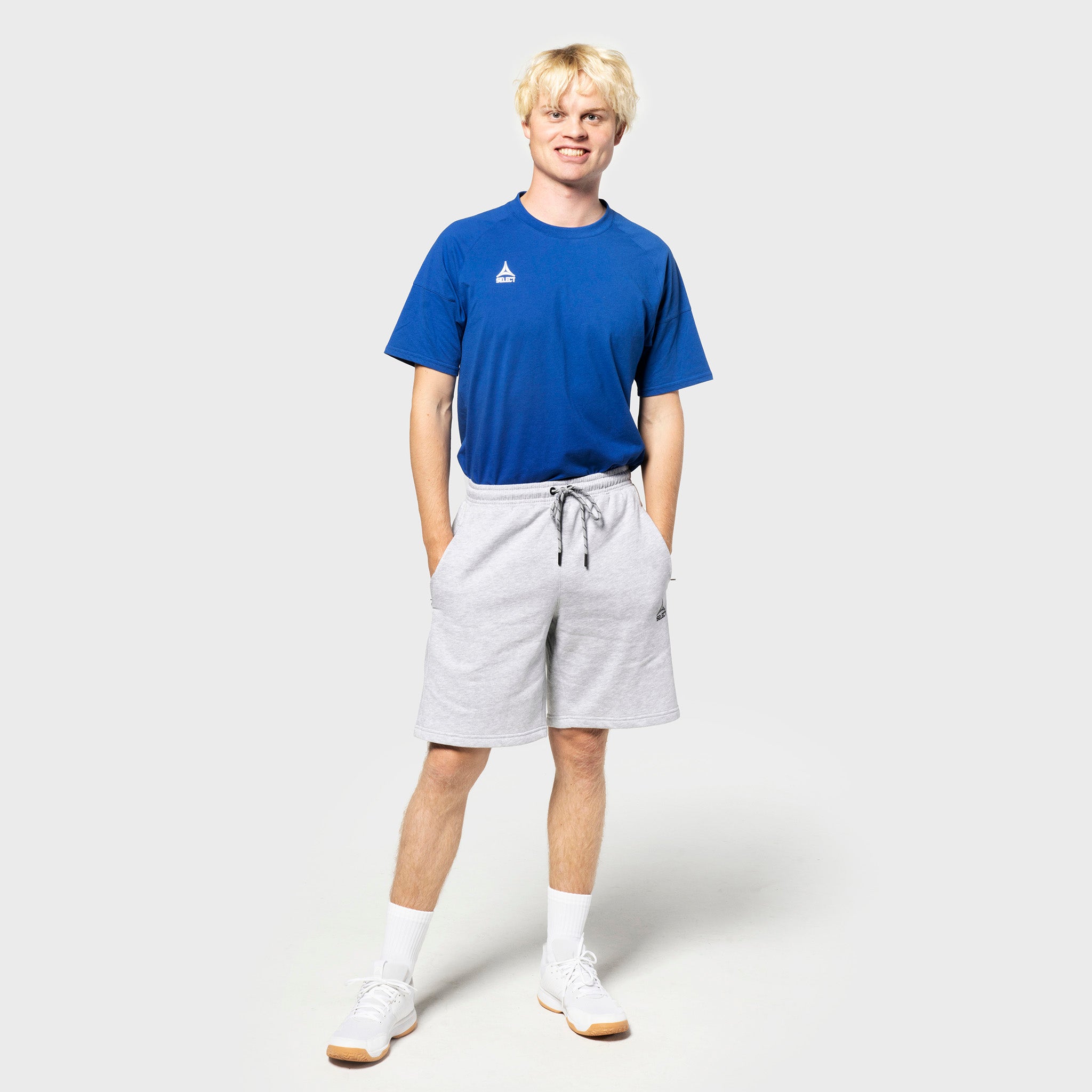 Male football player in blue tee and grey Sweat shorts Oxford v25, leisure wear, front view.