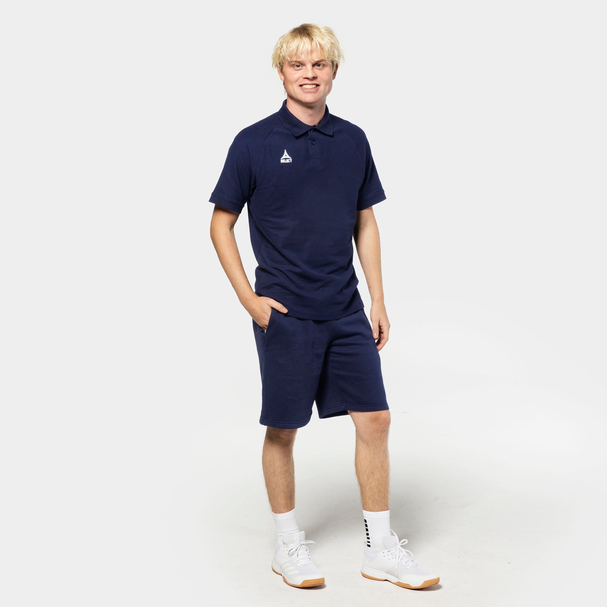Male football player in navy Sweat shorts Oxford v25 and matching polo, Leisure wear, front view.