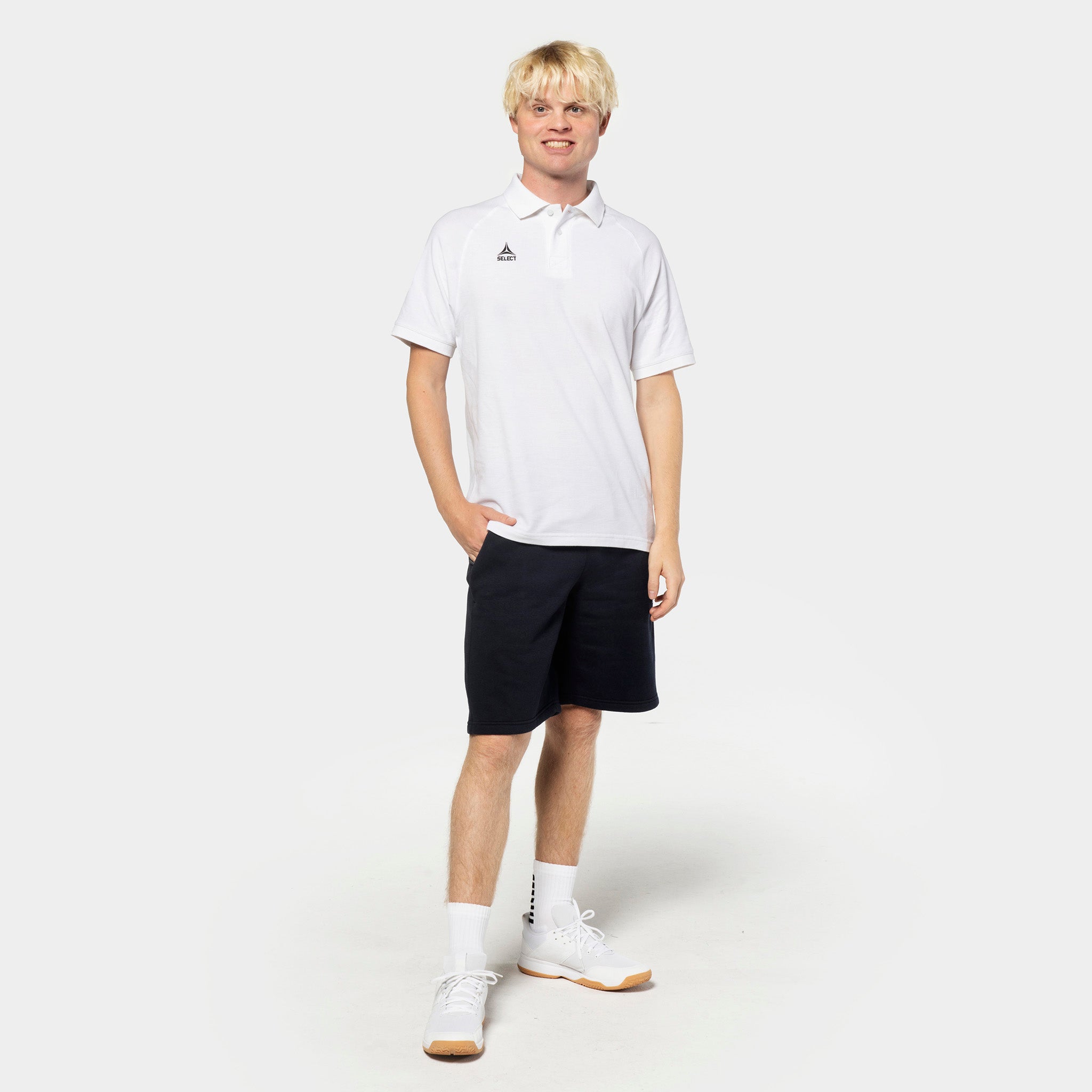 Man football player in white polo and black Sweat shorts Oxford v25, leisure wear, front view.