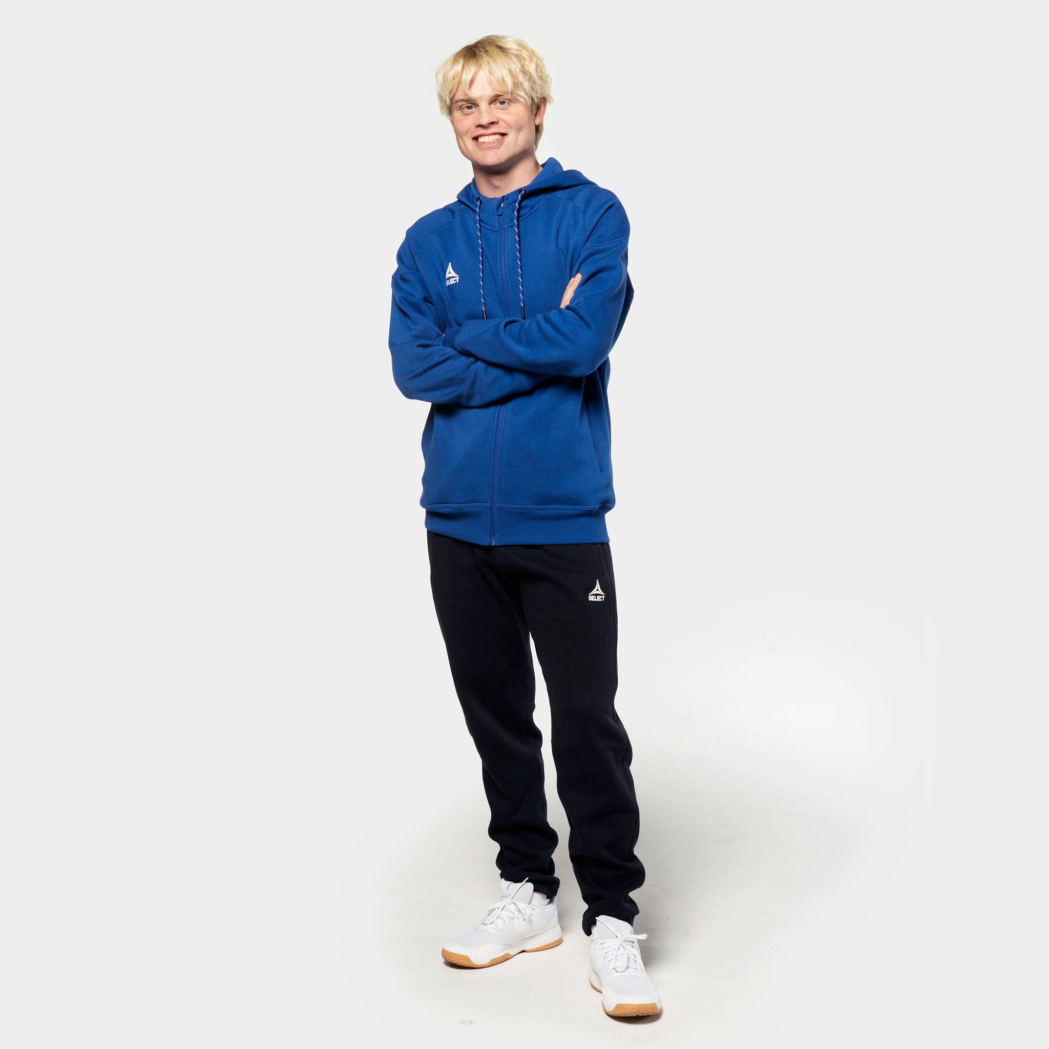 Man football player in blue zip hoodie and black Sweat pants Oxford v25, leisure wear, front view.