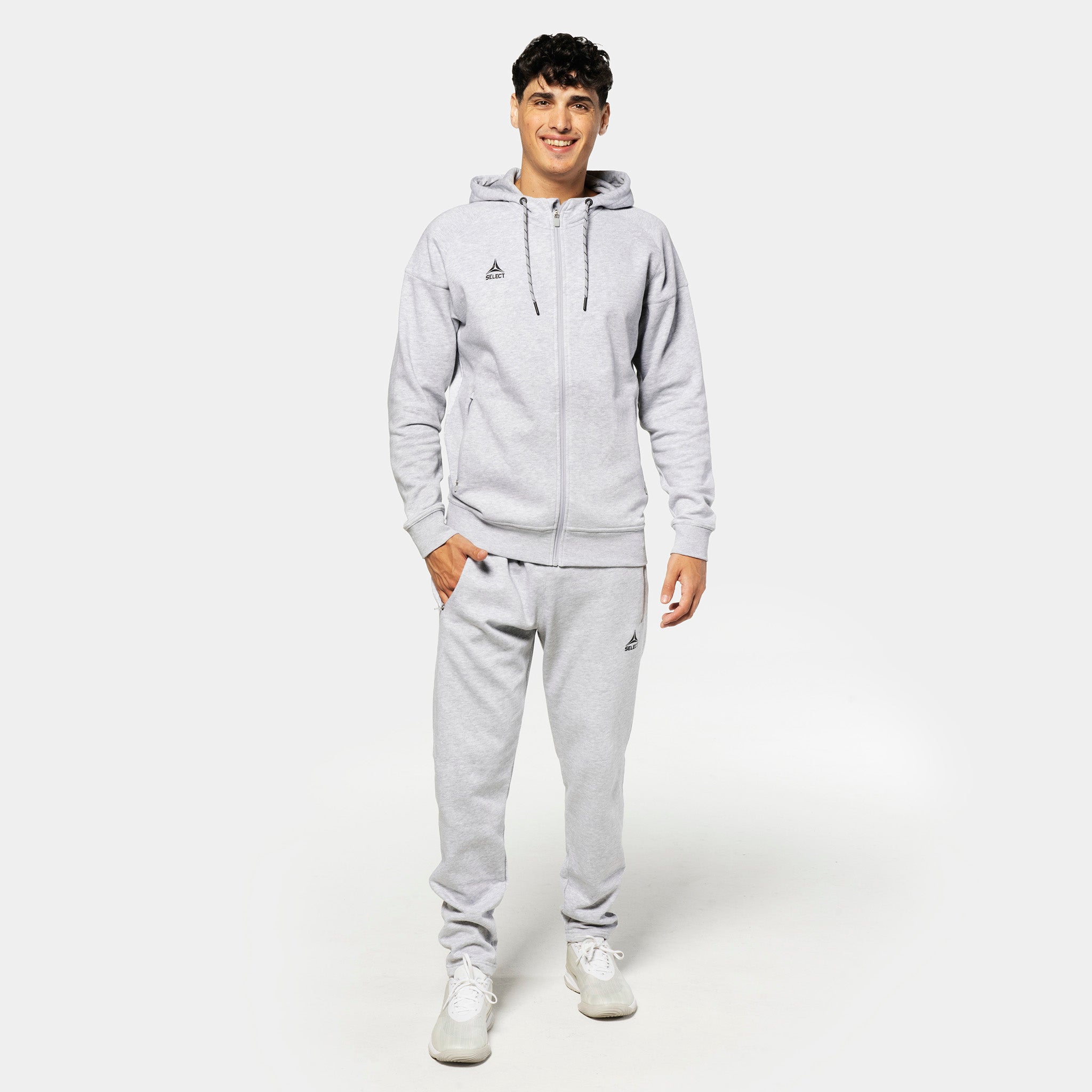 Man footballer in grey Sweat pants Oxford v25 with matching hoodie, leisure wear, front view.