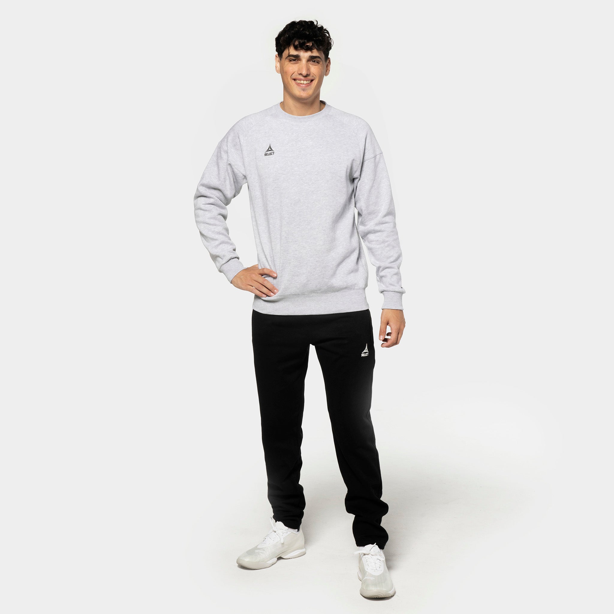 Male football player in grey sweatshirt and black Sweat pants Oxford v25, leisure wear, front view.
