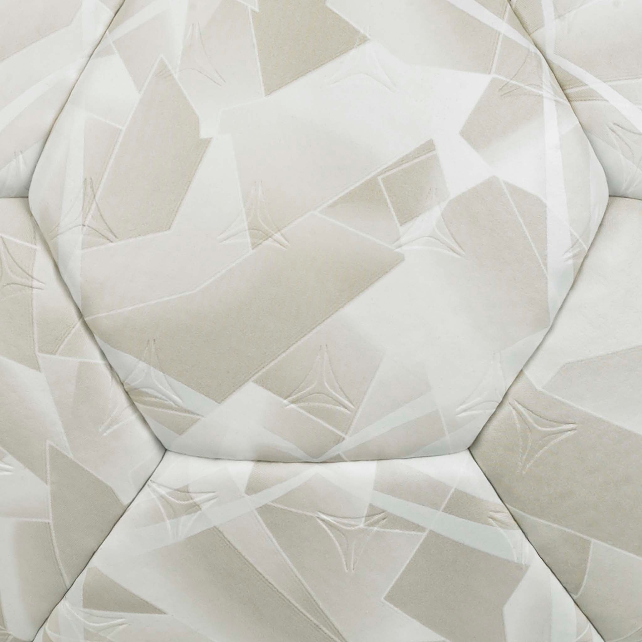 Closeup of white Solera v26 handball with beige geometric panel pattern and textured surface.